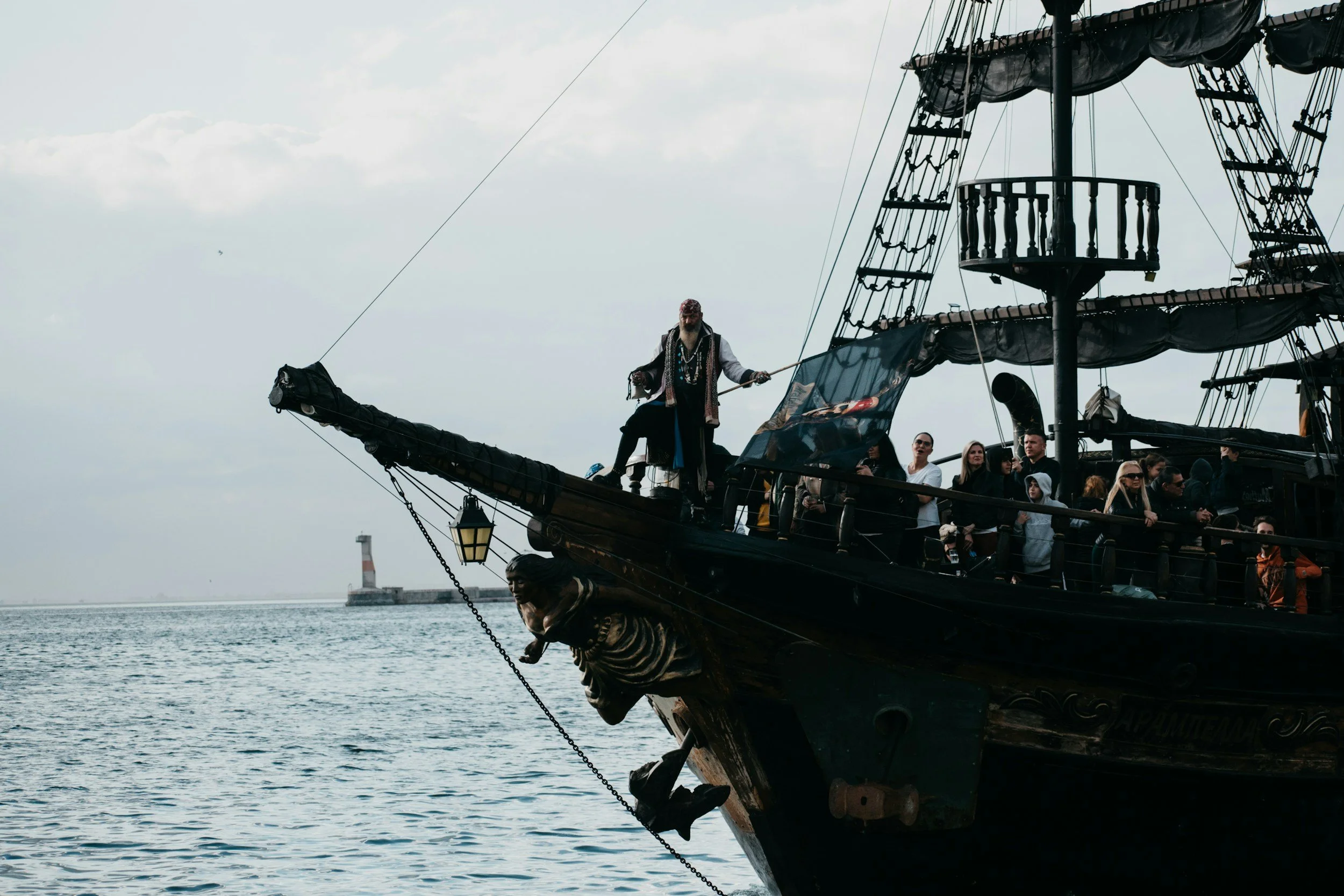 A pirate standing on the bow of a ship