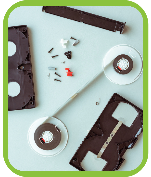 The pieces of a VHS cassette tape are organized on a light blue background.