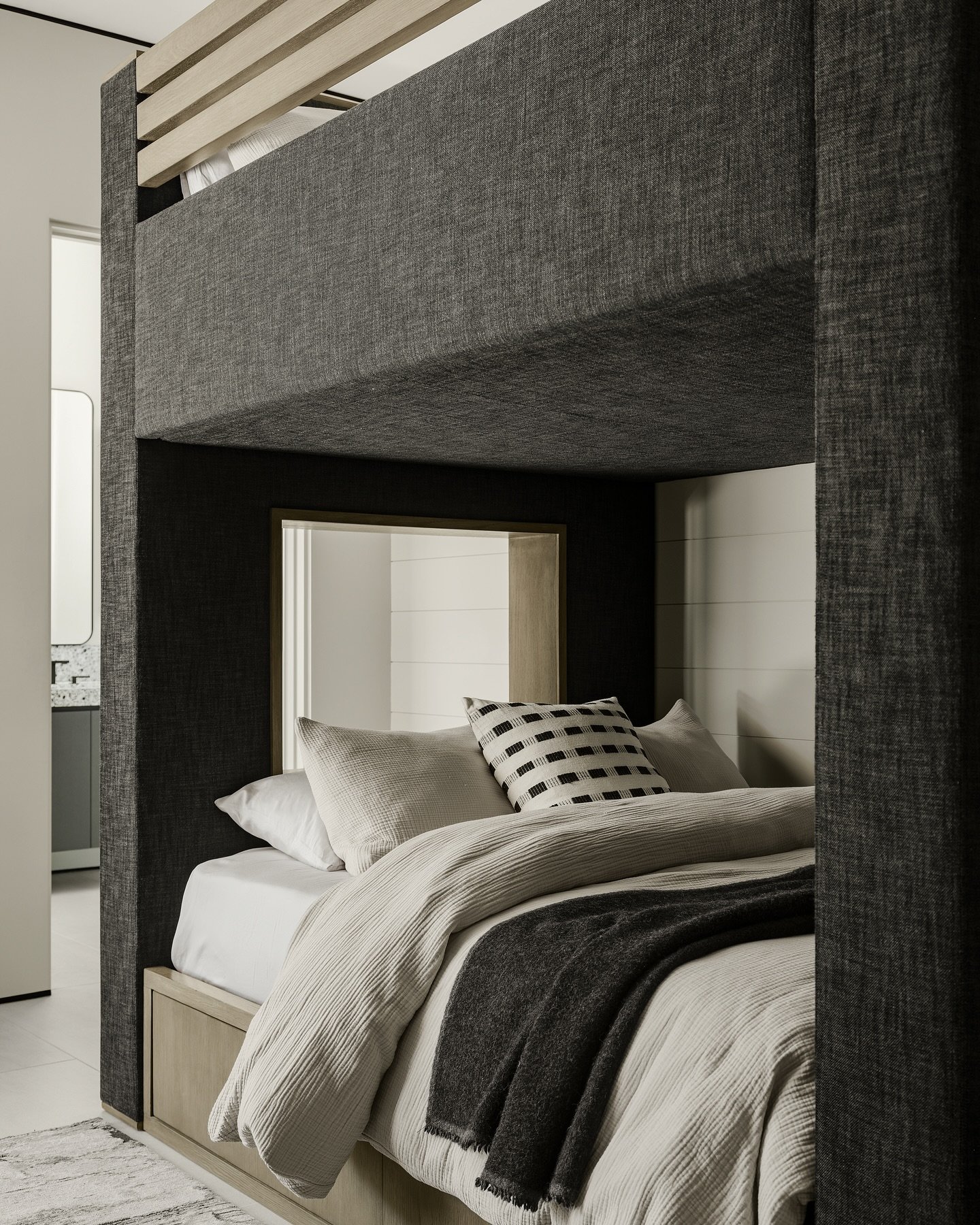 tailored &amp; tonal.
grey-washed oak and graphite linen shape a custom bunk that feels grounded and grown-up in this boys&rsquo; suite. the adjoining bath features graphic terrazzo counters and matte textured tile for a modern, playful feel.

projec