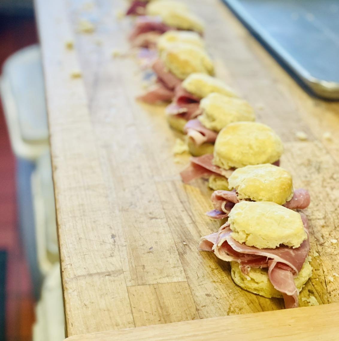 Every Saturday
We line these freshly baked biscuits up
Spread Holly Hill apple butter on each side
And place thinly sliced country ham  from Clifty Farm Country Meats in between! 

You can also order these any day of the week for pick up!