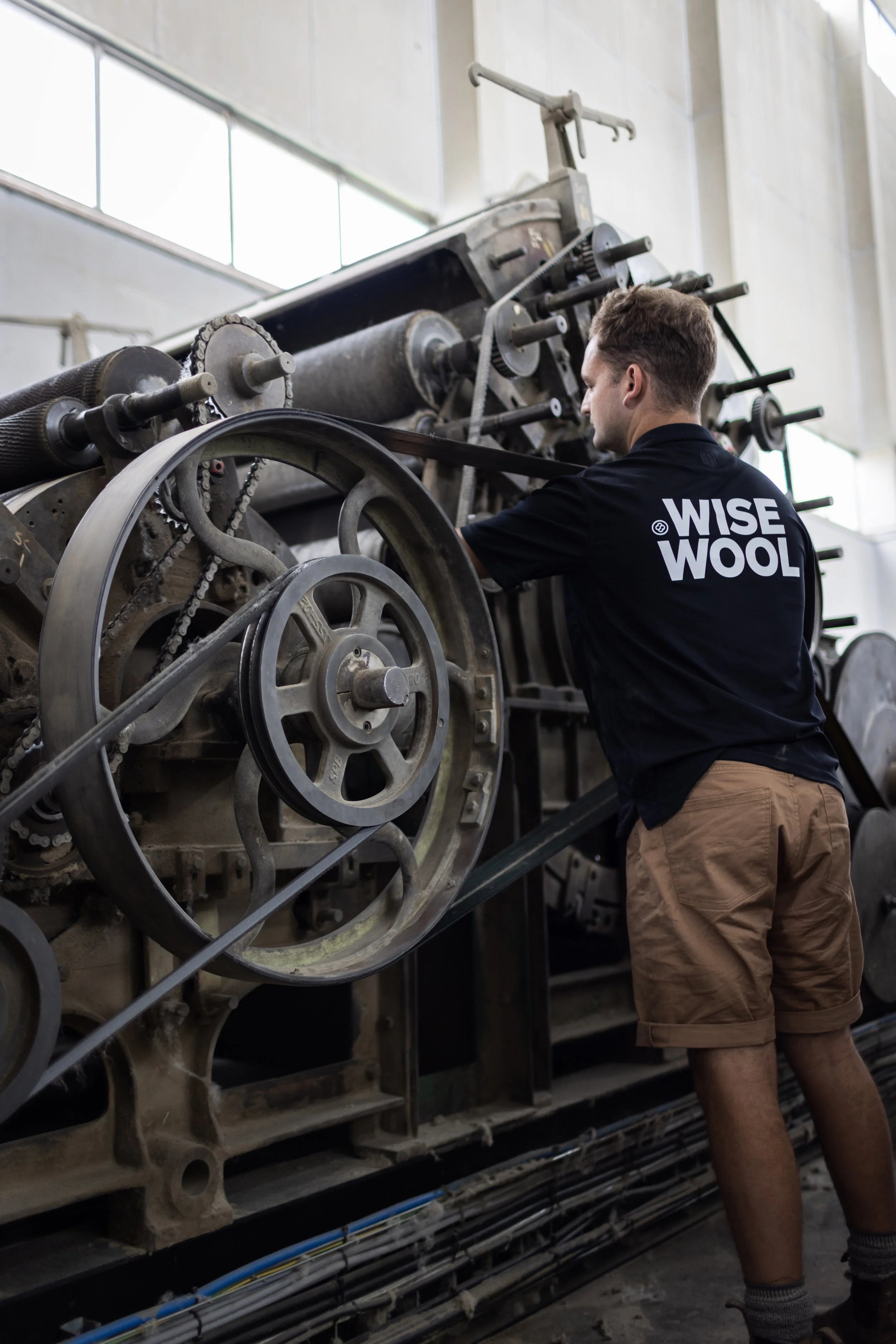 Angus Hansen operating a wool Carding machine at the Te Poi Factory.