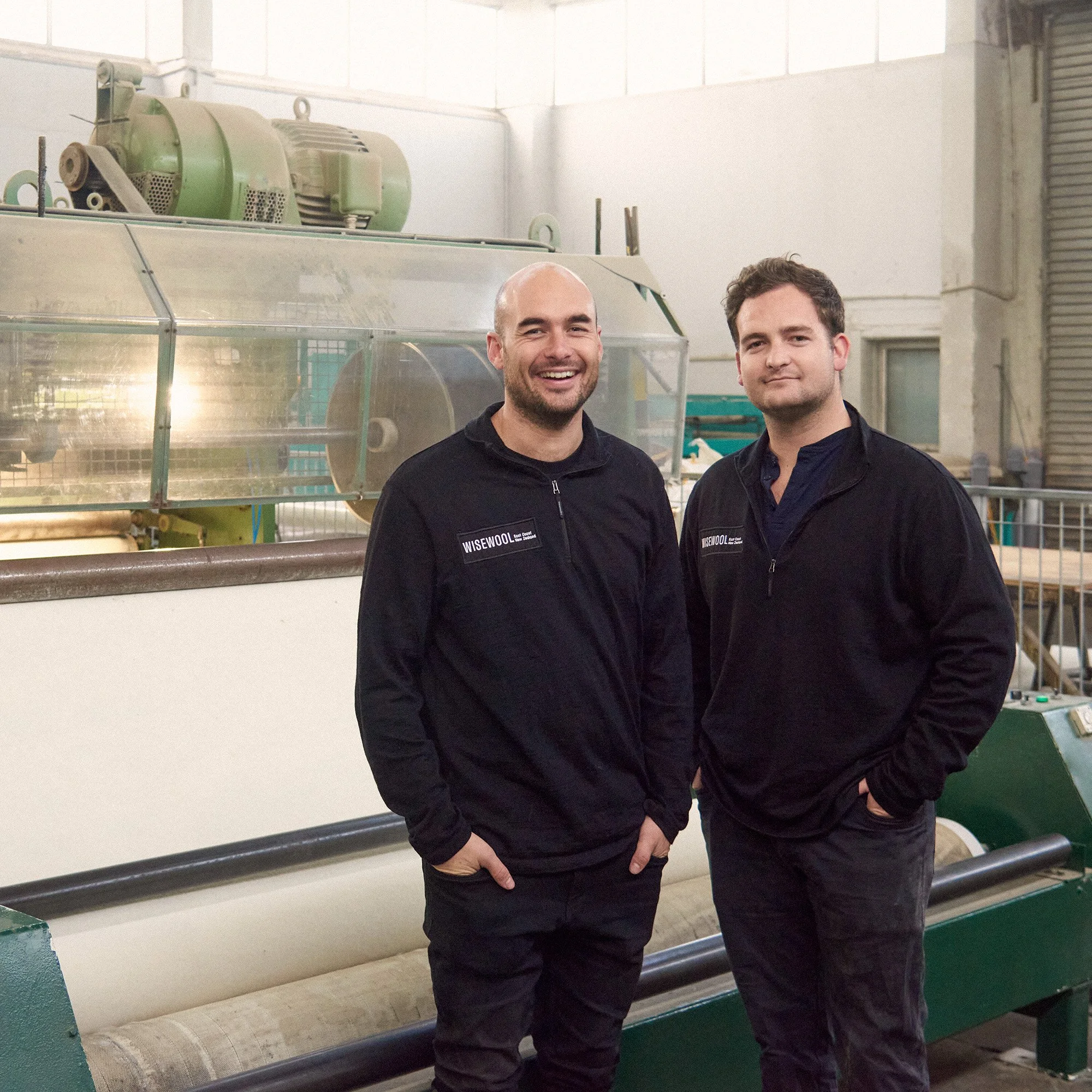 Harry Urquhart-Hay and Angus Hansen in front of the Wiselayer™ machine at the Wisewool™ factory in Te Poi.