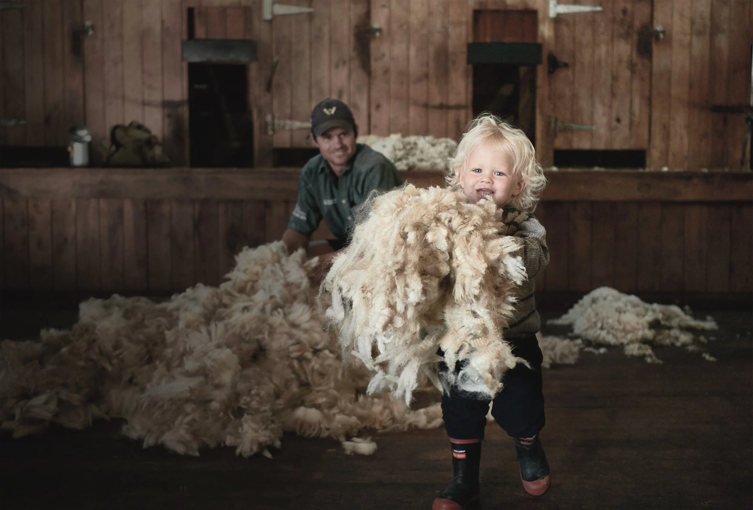 Fraser Tombleson and one of his children at their farm Aerial Station, one of the Gisborne sheep stations supplying wool to Wisewool™.