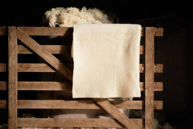 Wisefill™ and Wiselayer™ products displayed in a barn and hanging over the gate fence.