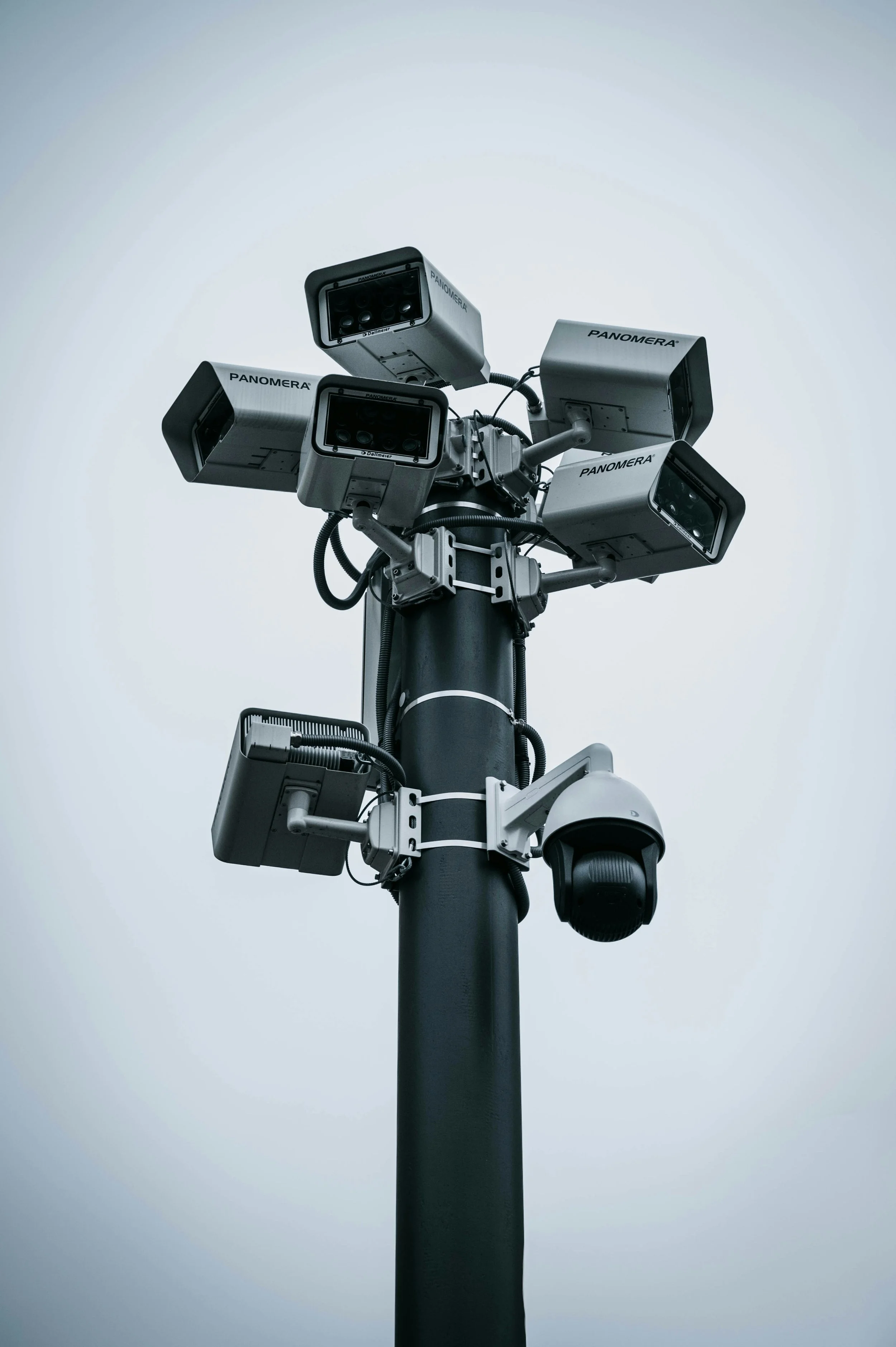 A pole with multiple surveillance cameras
