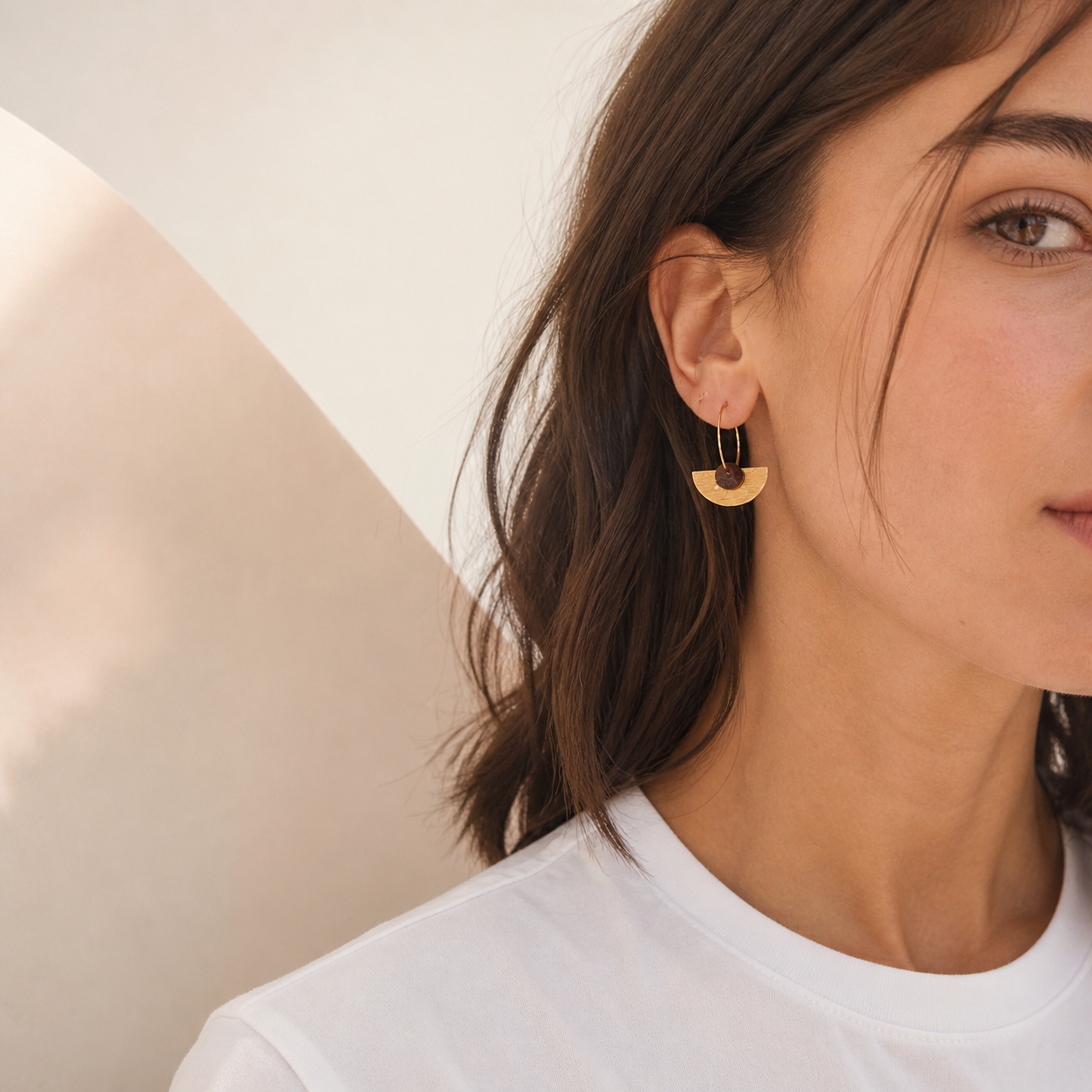 Woman wearing recycled coffee gem hoop earrings with gold semi-circle detail, minimalist everyday jewellery Melbourne