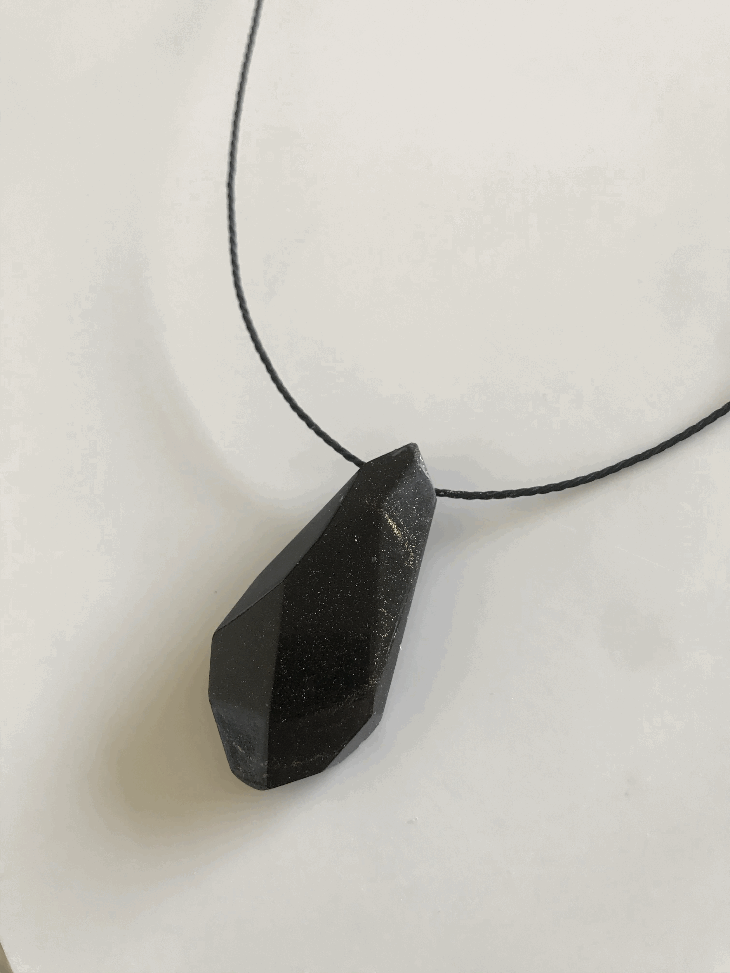 Faceted pendant adjustable black rope. Made with used coffee ground.