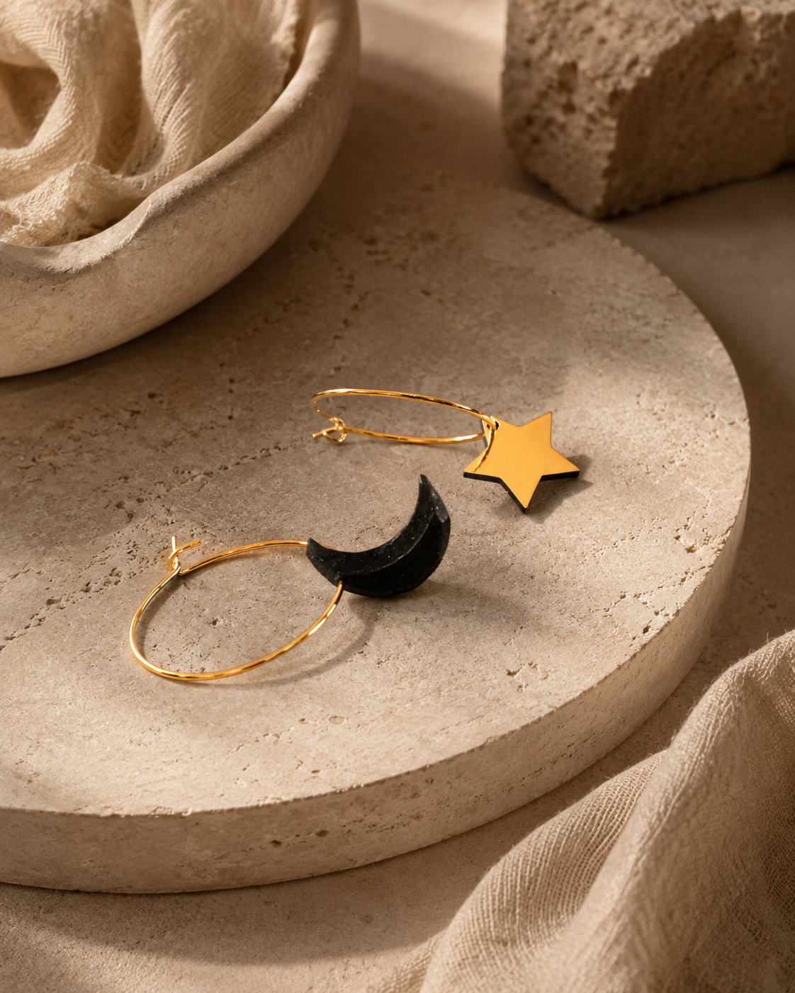 Galaxy moon and star earrings laid on textured stone, celestial handmade jewellery crafted in Melbourne from recycled coffee grounds.