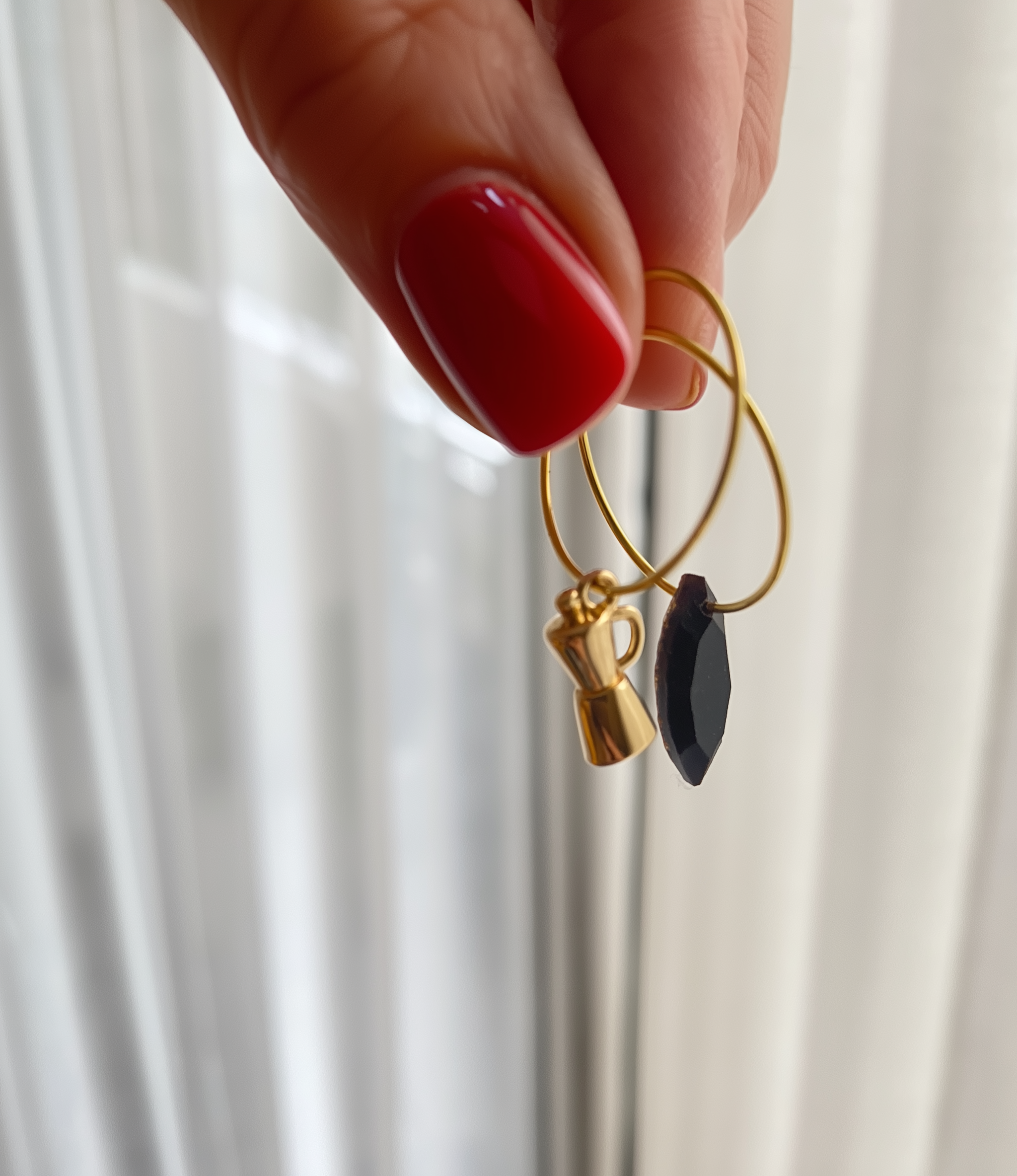 u5572191459_beautiful_hand_with_perfect_red_nails_holding_earri_391a7705-220b-4b92-a956-cf9462d57f0c.png