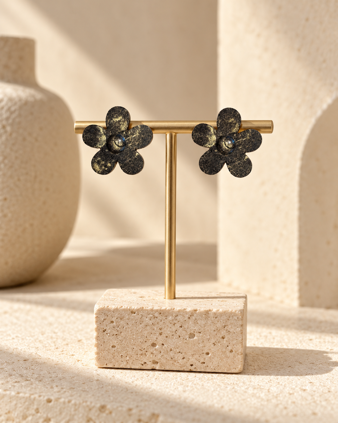 Nebula Bloom coffee-stone flower earrings displayed on a gold jewellery stand in a warm neutral studio.