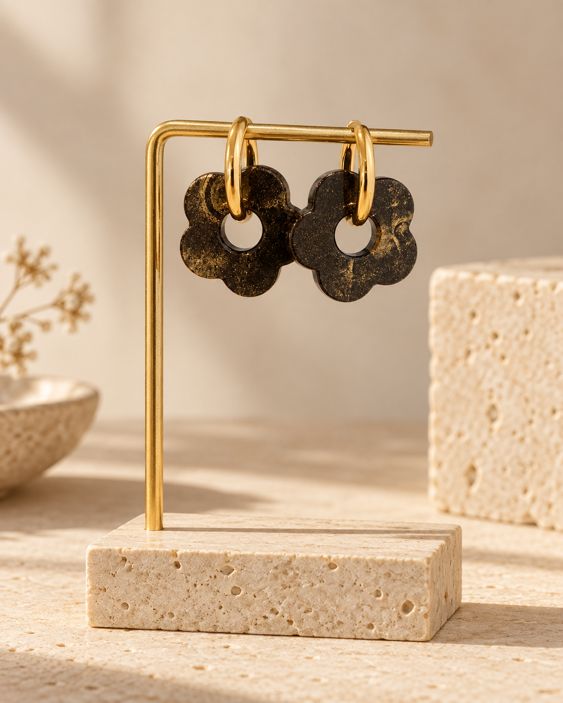 Liberica coffee-stone flower hoop earrings with 18K gold-plated hoops, displayed on a gold jewellery stand against a warm stone setting.