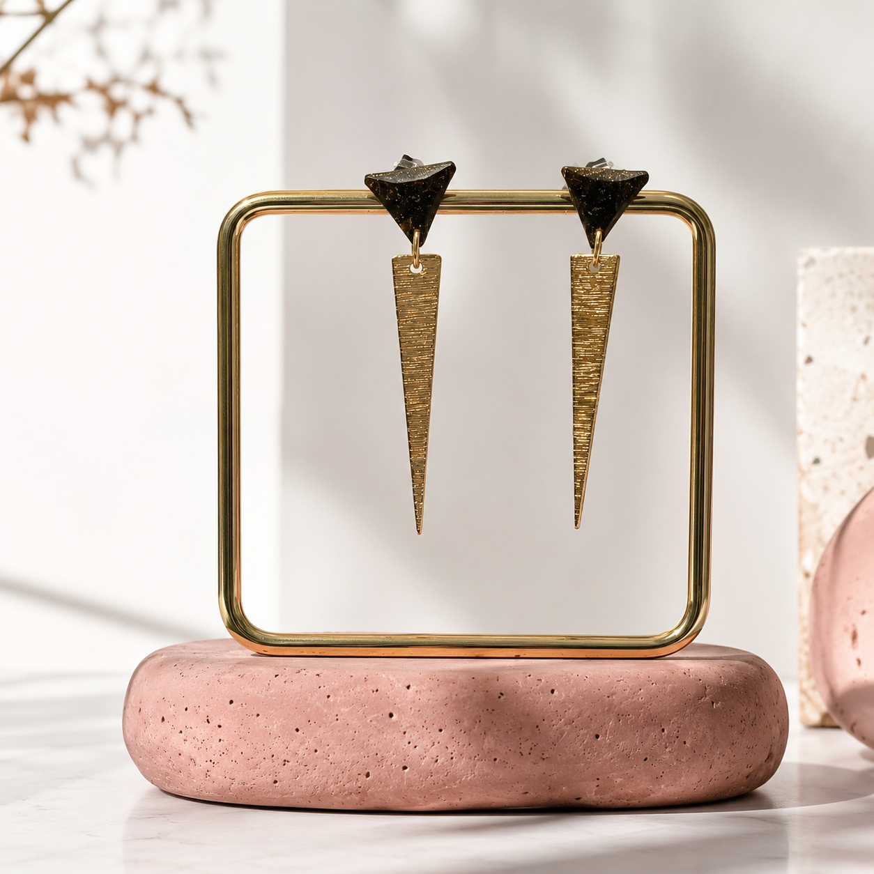 Goldies geometric drop earrings by Atelier Cayelle on a display stand, a unique sustainable jewellery gift made in Melbourne.