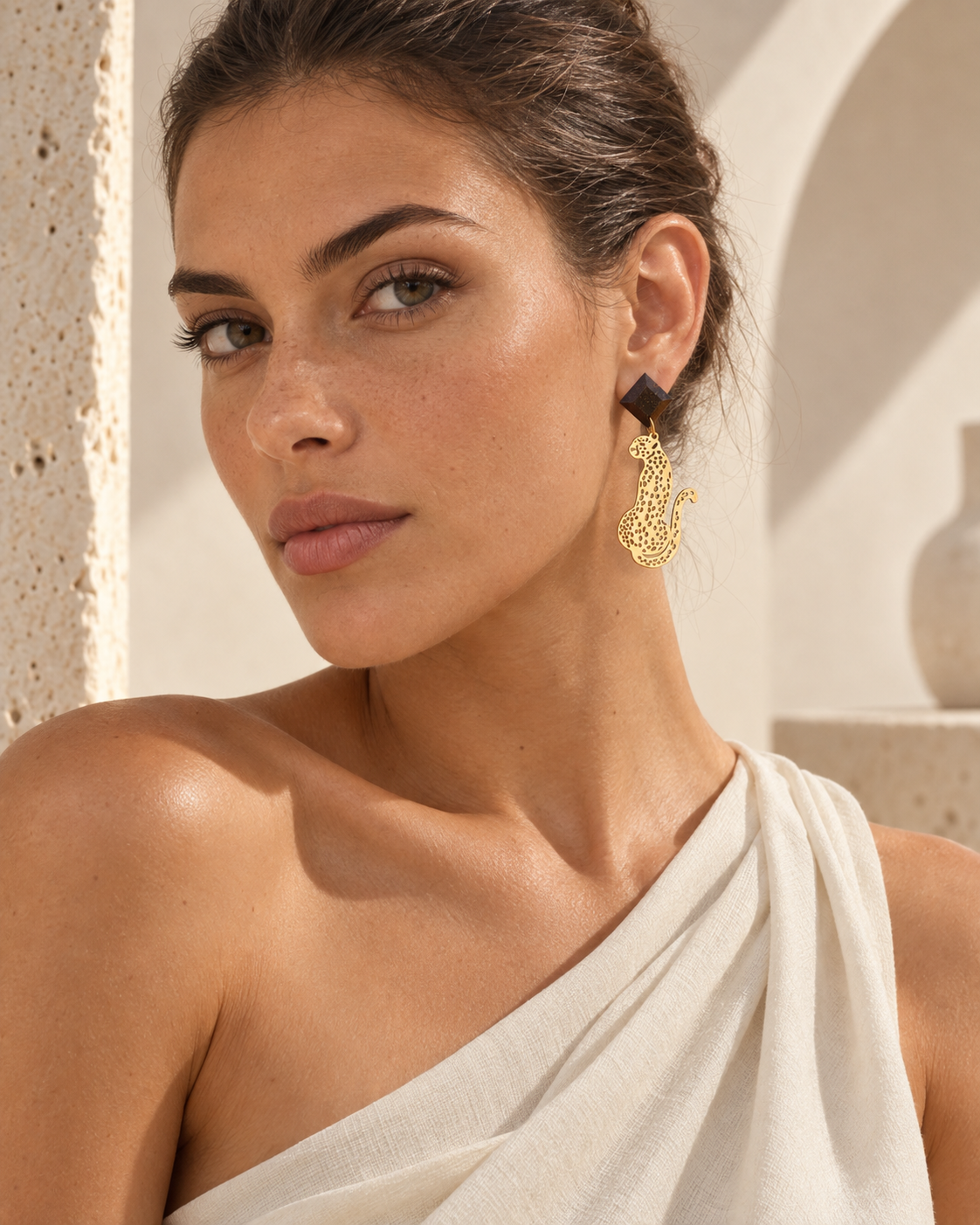 Side view of Macula coffee-stone leopard earring worn on the ear, showing its scale, faceted stud and gold-plated design.