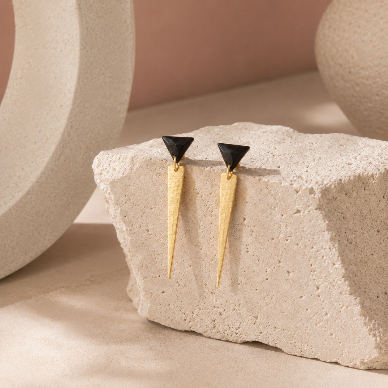 Goldies handmade statement earrings displayed on textured stone, Australian-made jewellery gift crafted from recycled coffee grounds and gold powder.