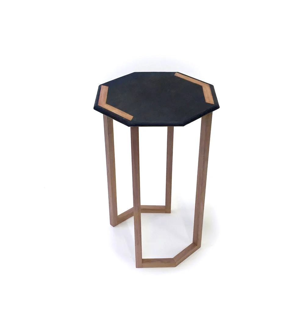 Hexagonal side table with wooden legs and dark top make with recycled coffee. Student remit furniture design Melbourne.