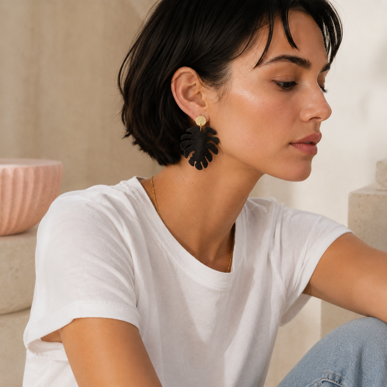 Model wearing Nerea recycled coffee earrings, a unique artisan jewellery gift in a modern neutral studio setting.