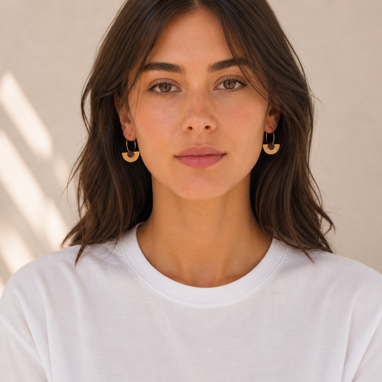 Front portrait of woman wearing recycled coffee gem hoop earrings, lightweight gold hoop earrings handmade in Melbourne