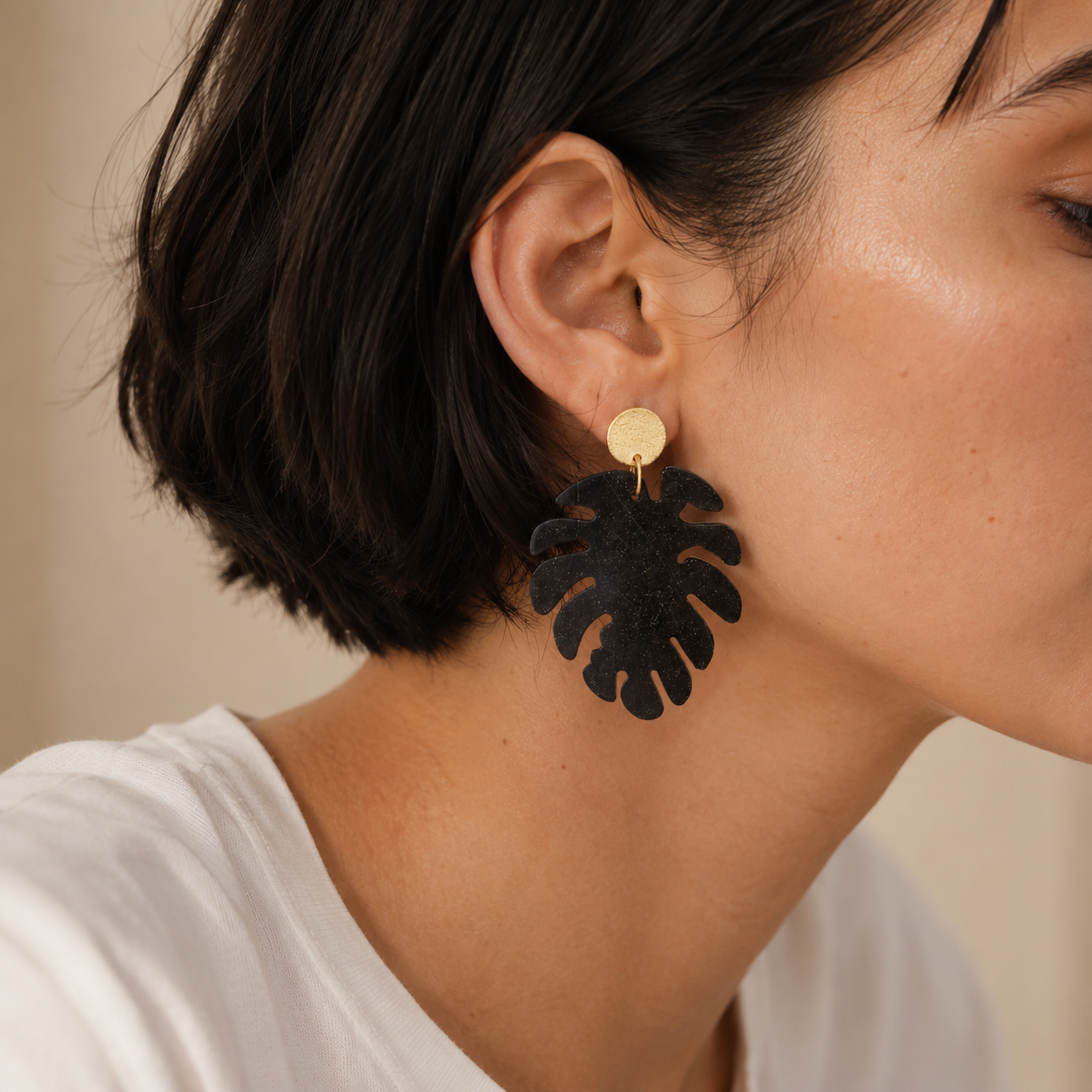 Model wearing Nerea Monstera leaf earring made from recycled coffee grounds, a lightweight gift for coffee lovers.