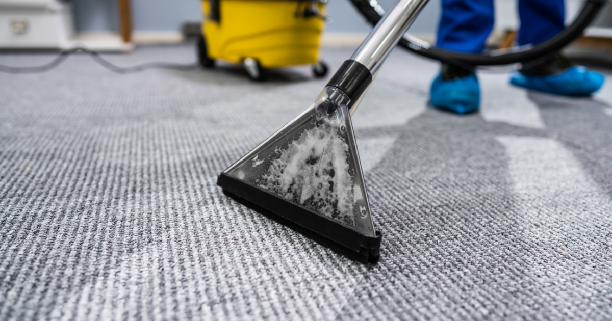 janitor cleaning carpets with a machine using soap and water