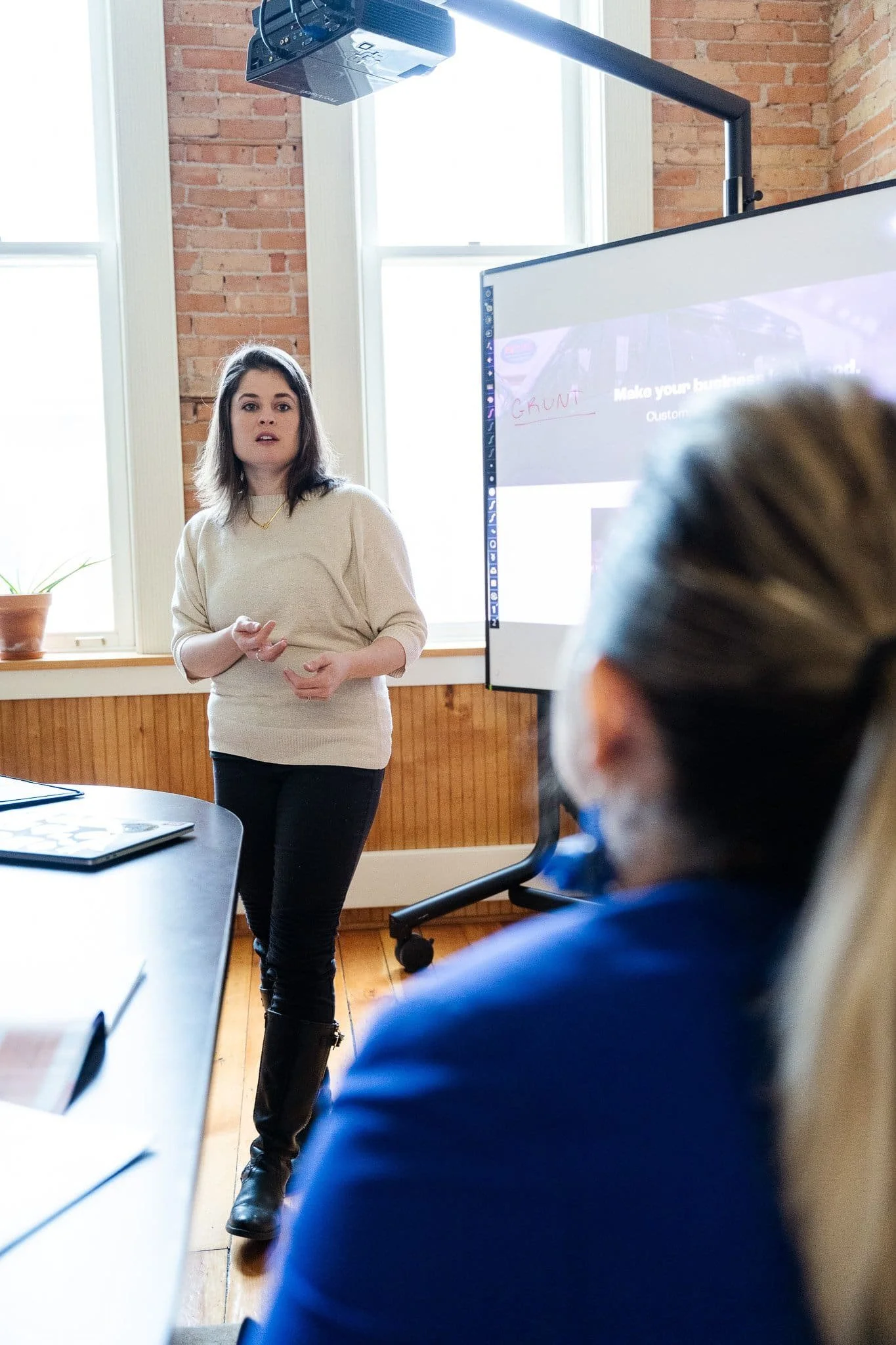 Amanda Garcia, CEO of ColorWord Creative,  making a website marketing presentation.