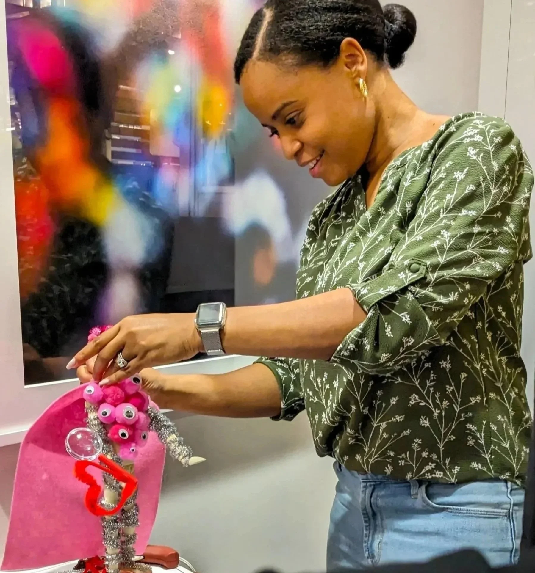 Team members creating colorful 3D art gifts for colleagues during Make Believe Works team building activity