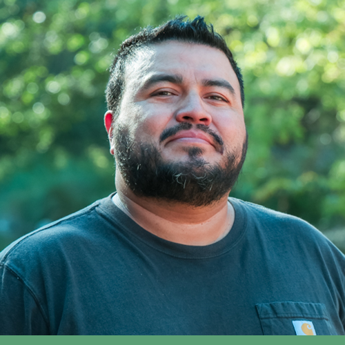 Eric Buenrostro Headshot against a green background