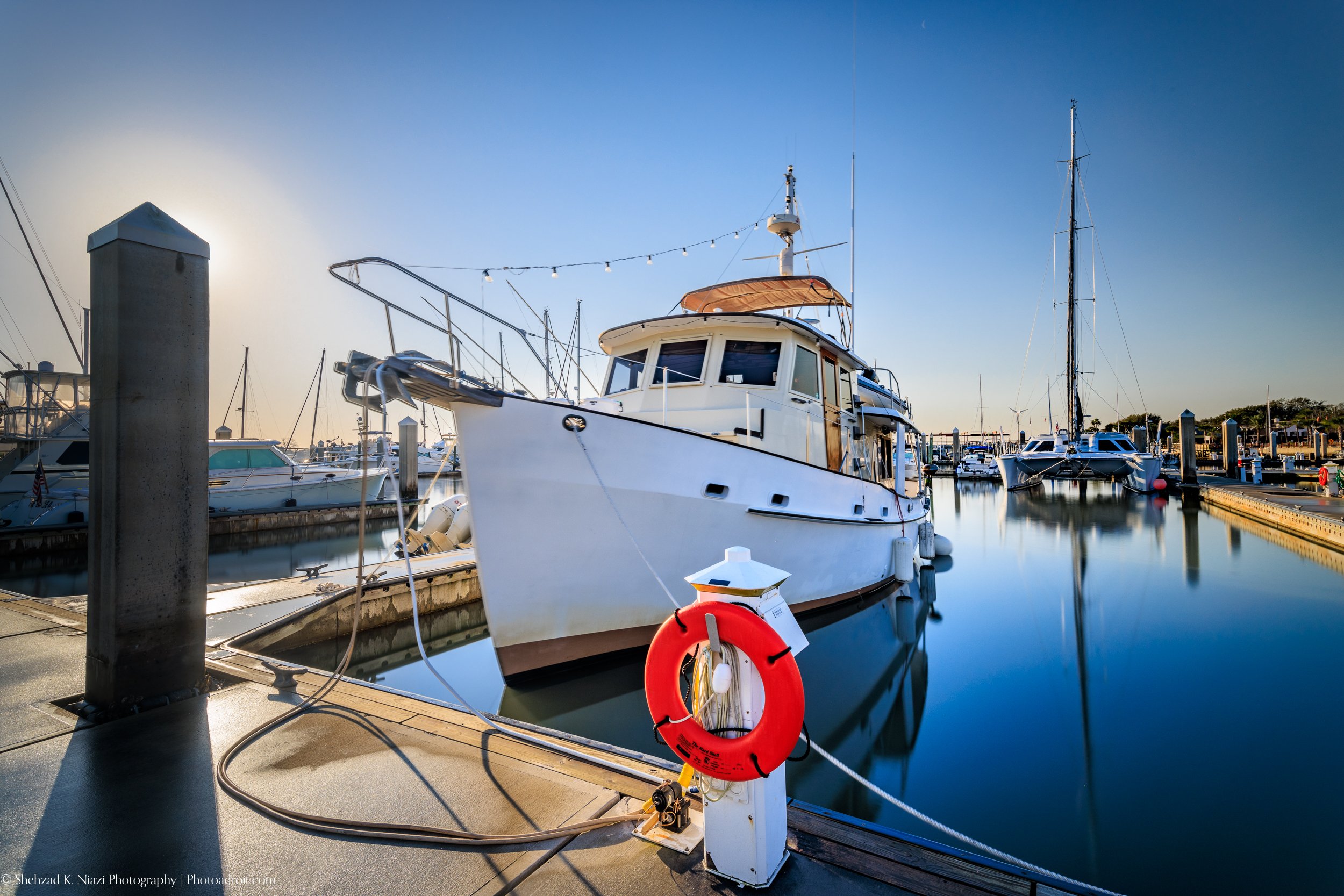 Boat docked in Marina at Downtown St Augustine and its reflections.jpg