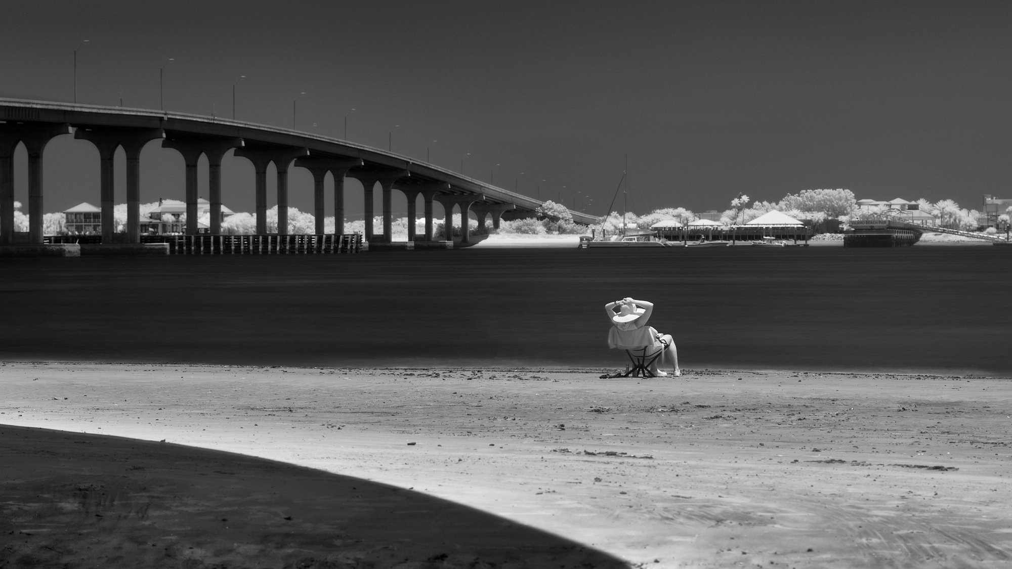 The solitary figure seeking shade beneath the monolith