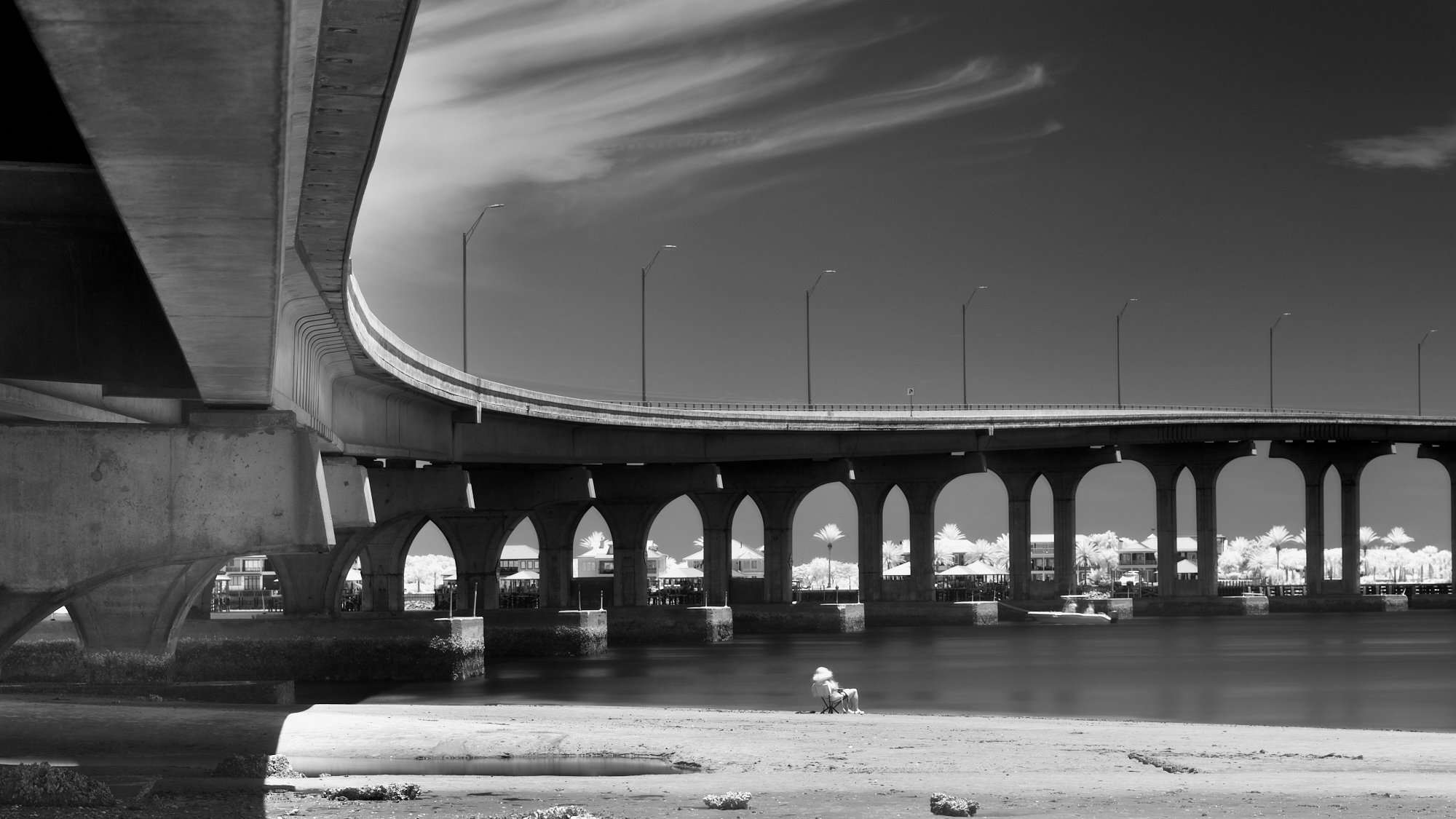 B&W infrared of Vilano Bridge and a solitary figure by the Tolomato River.