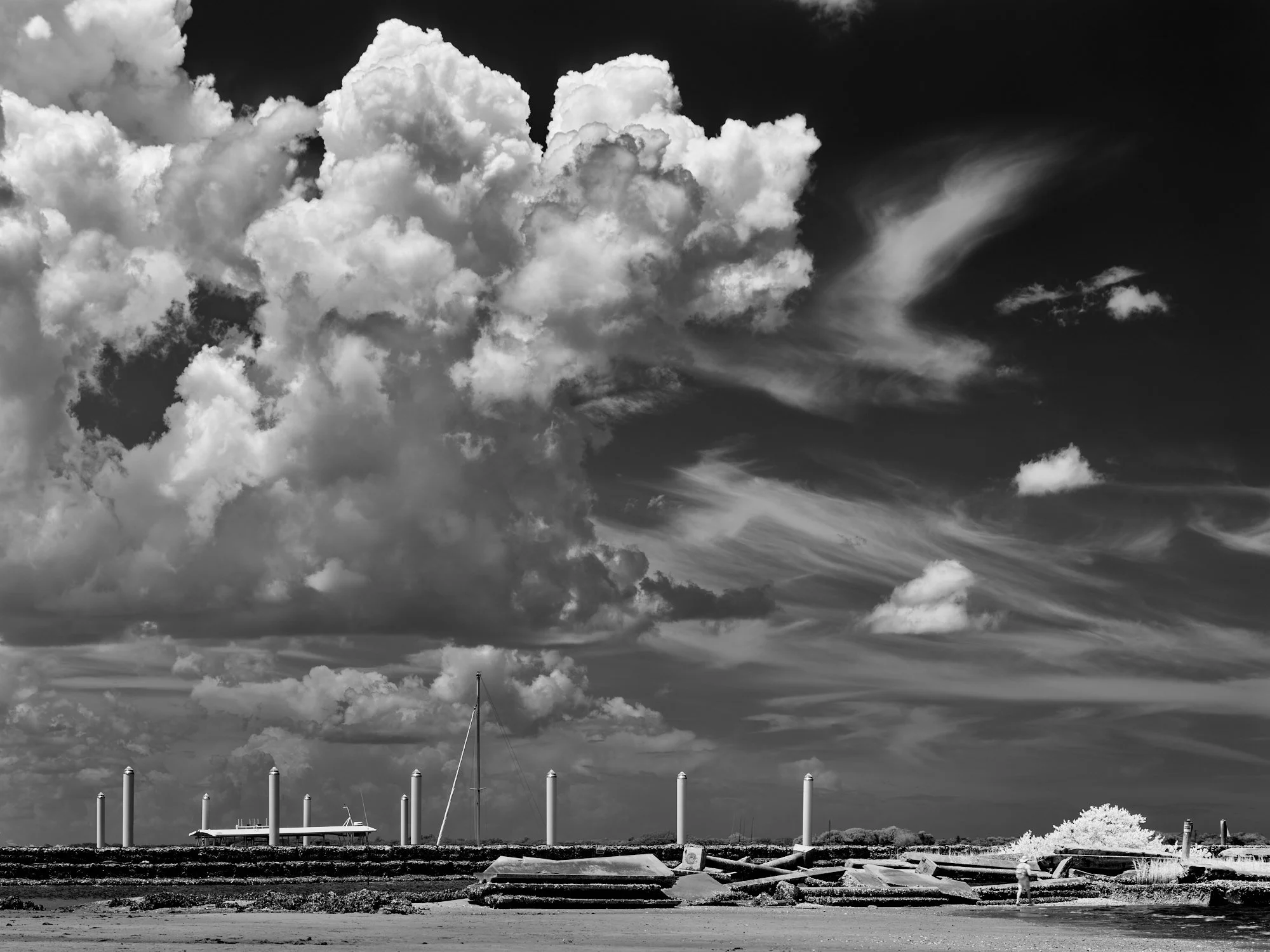 B&W infrared of concrete rubble under a turbulent sky in Vilano, FL