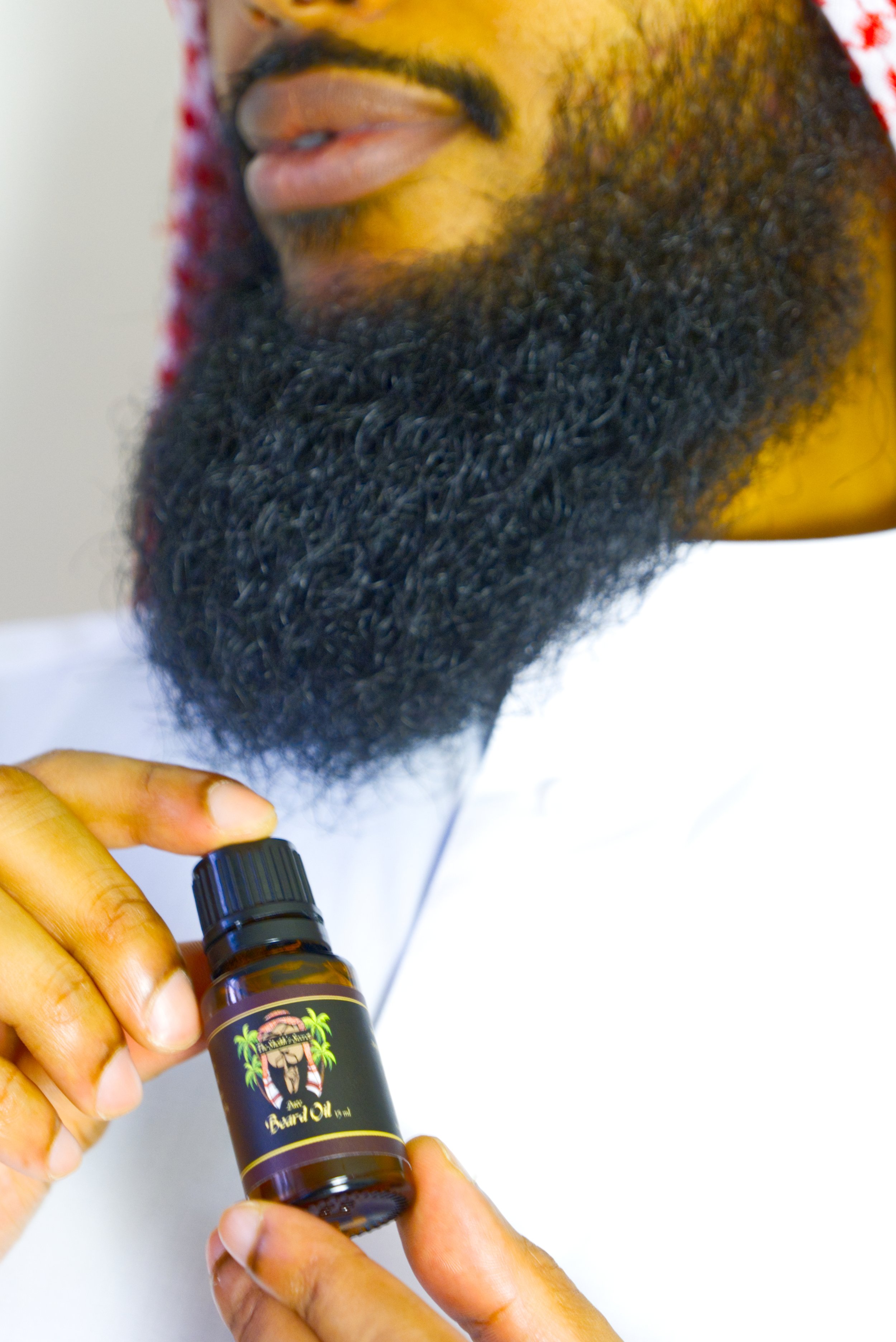 sheikh side profile holding beard oil png