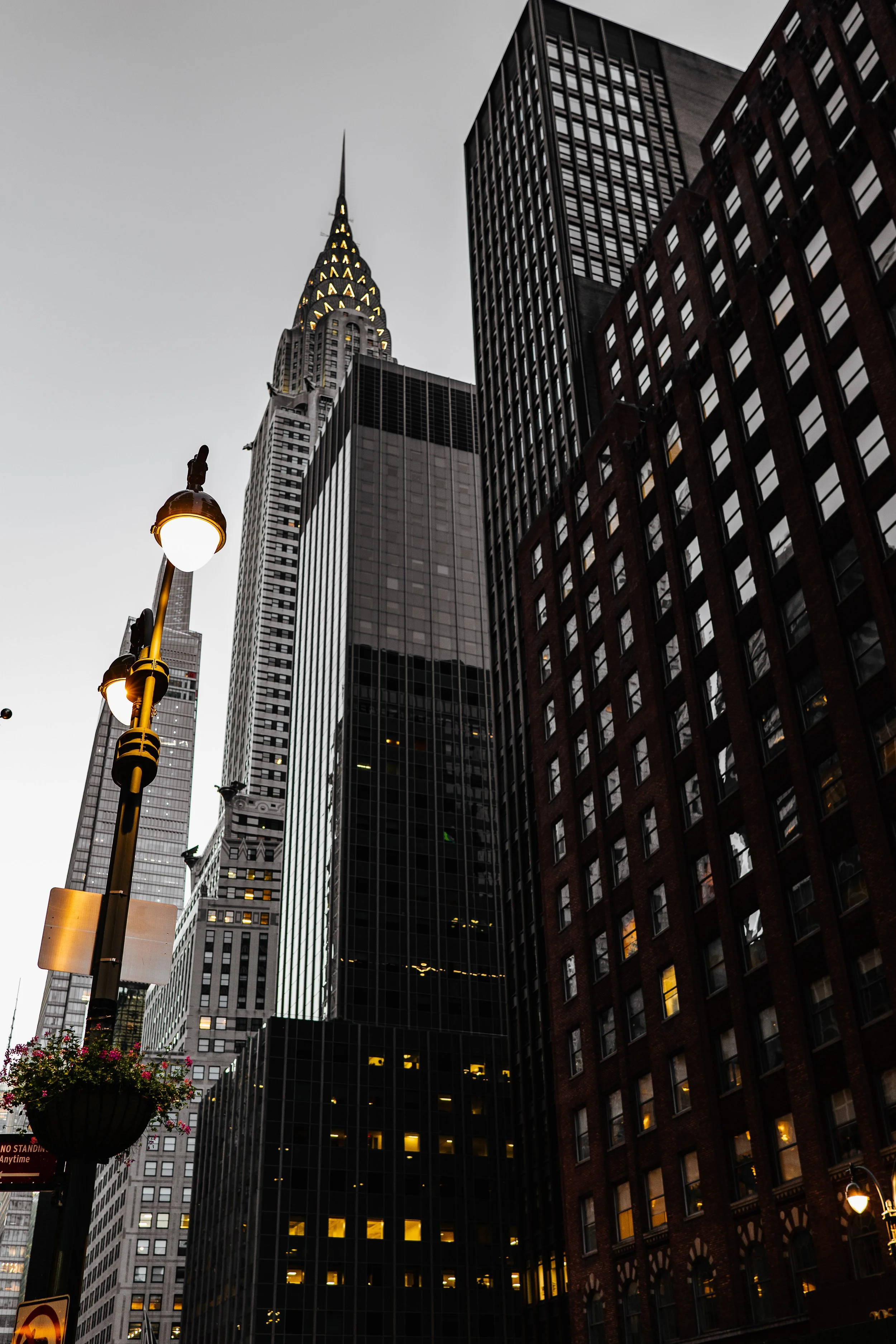Street view of skyscrapers with a lamppost and the Chrysler Building in New York City.
