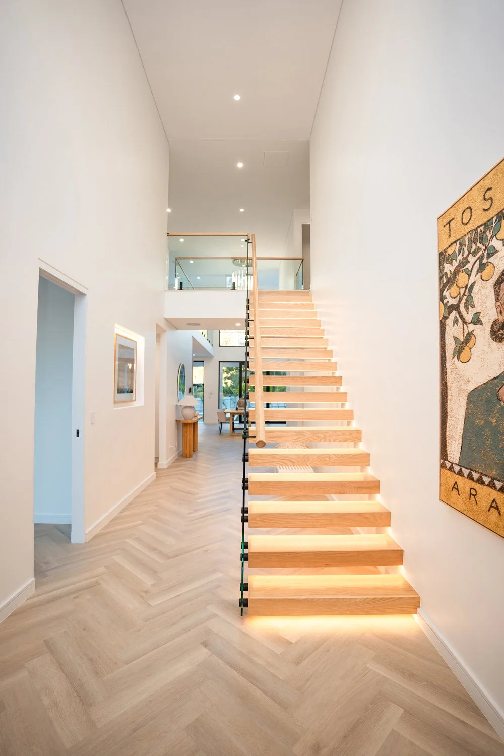 Custom home build in Forestville NSW with Timber monostring stair case, herringbone flooring, light neutral colours.