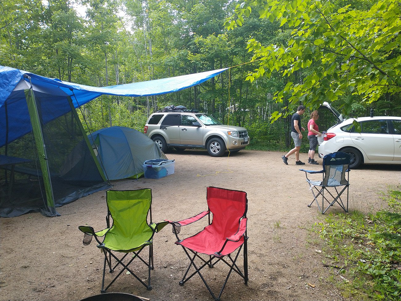 Campsite for 3 people. Notice the tarp and mosquito net over the picnic table. Die mosquitos.