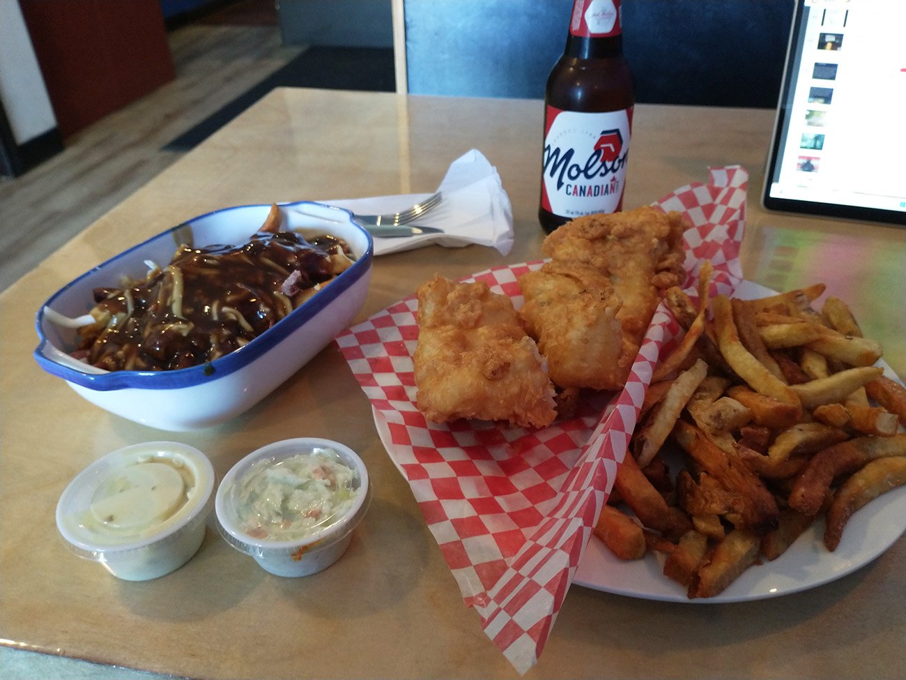 Got myself a greasy meal of fish and chips ( was very good ) and a poutine with salted beef ( an island ingredient ) that also was delicious. #deserve