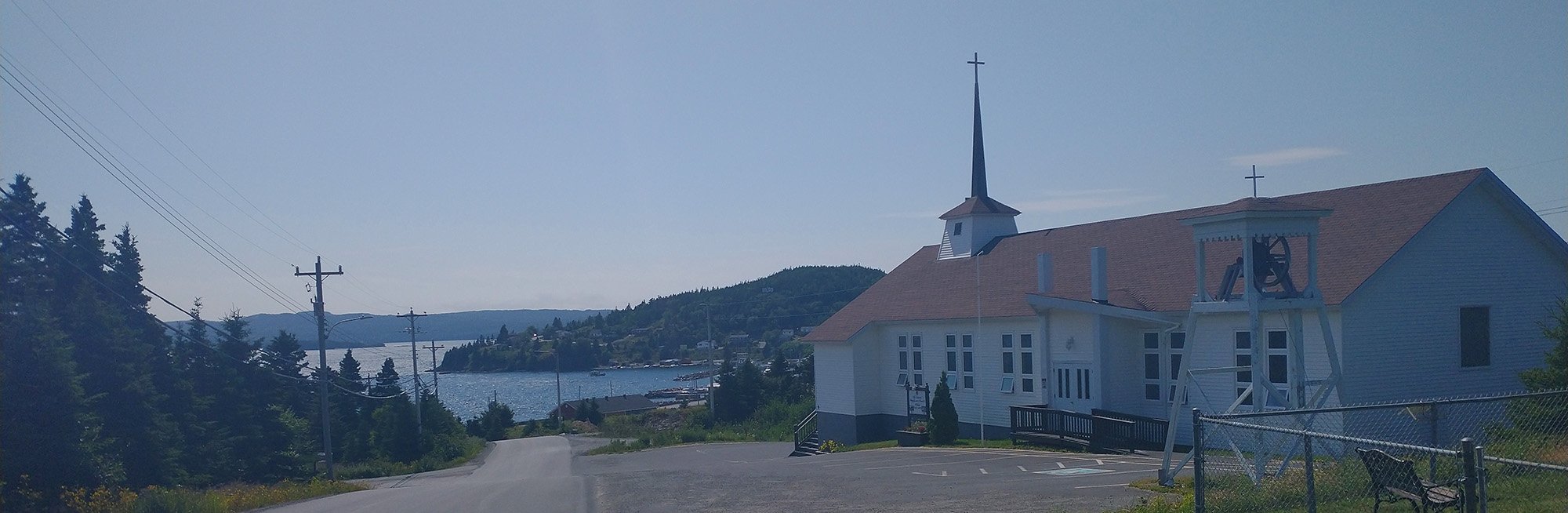 View of the town as you come down the little hill into it. Church, hill, marina. Cove town.