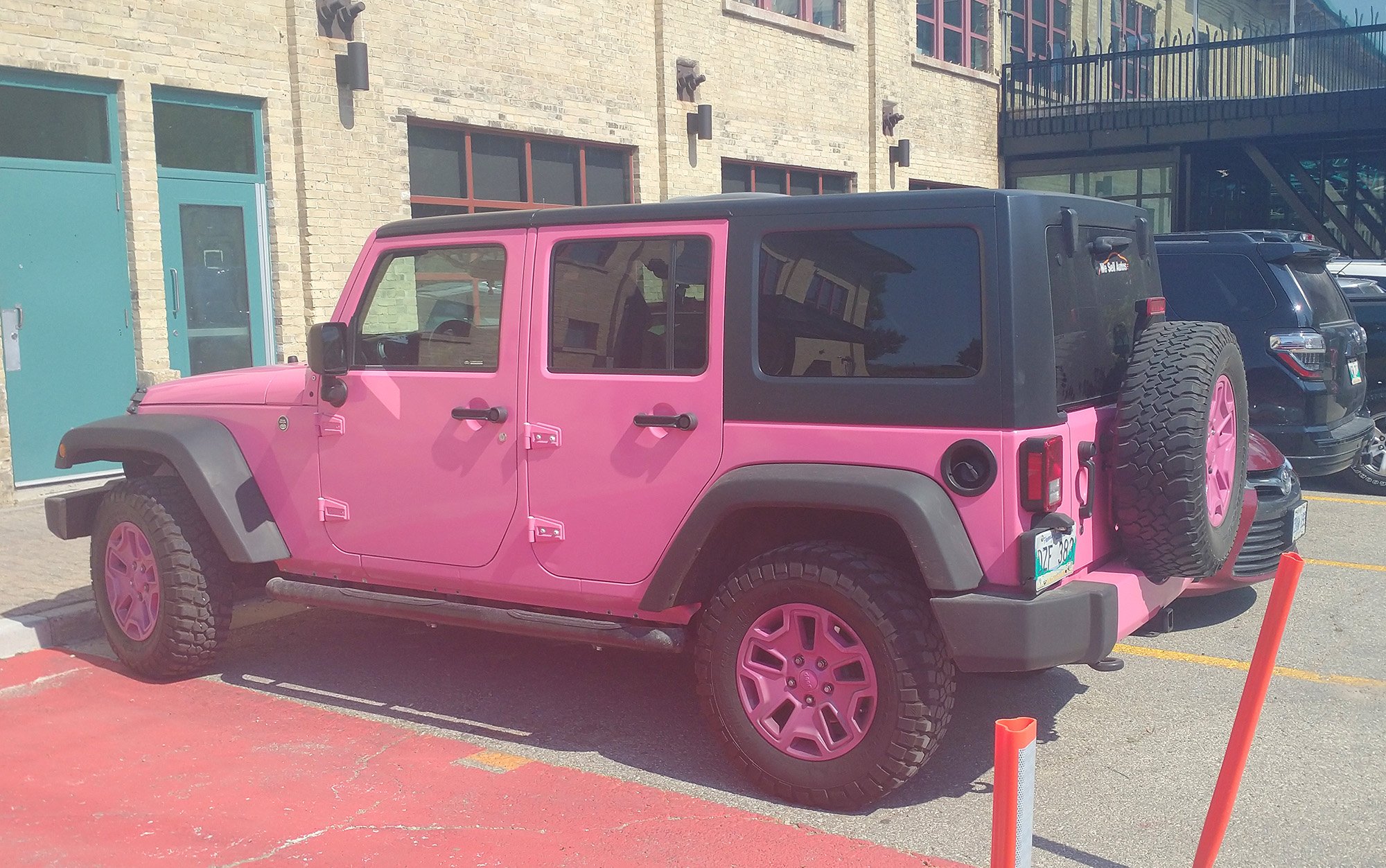 Expensive looking pink jeep in the touristy part of town called "The Forks".