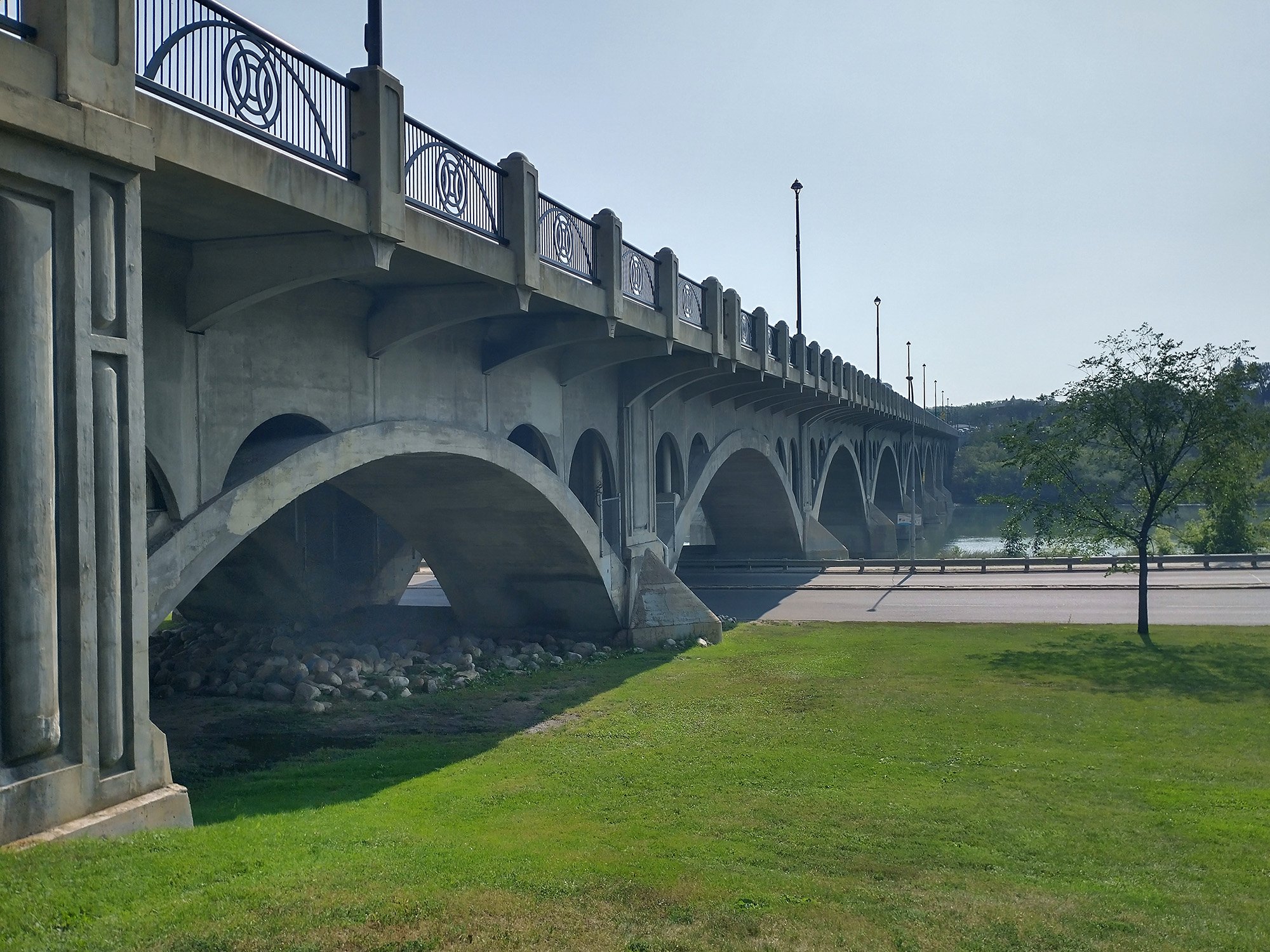 Under the large bridge that crosses the river downtown.