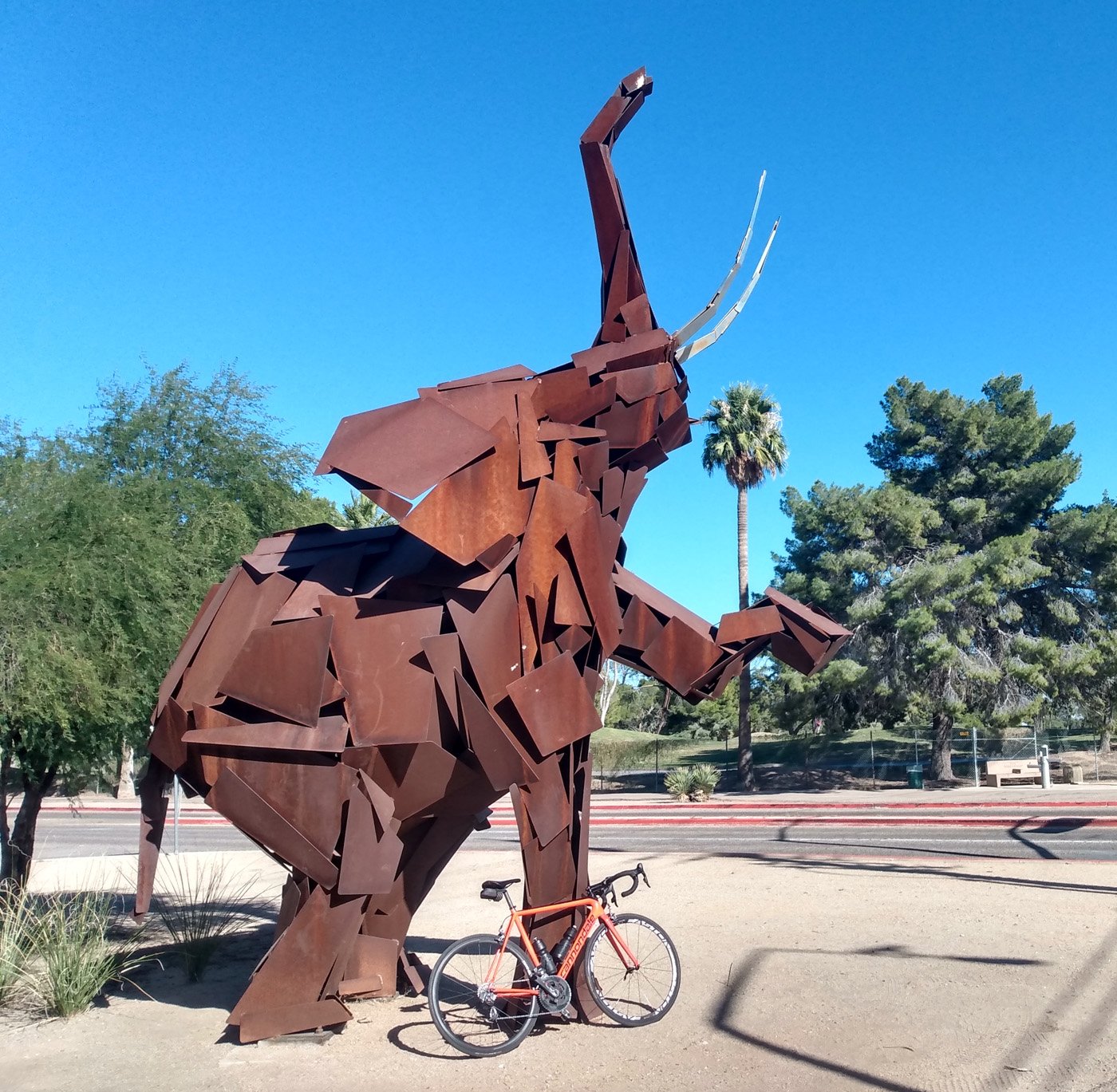 Big chonky rust elephant in front of the Tuscon Zoo entrance.