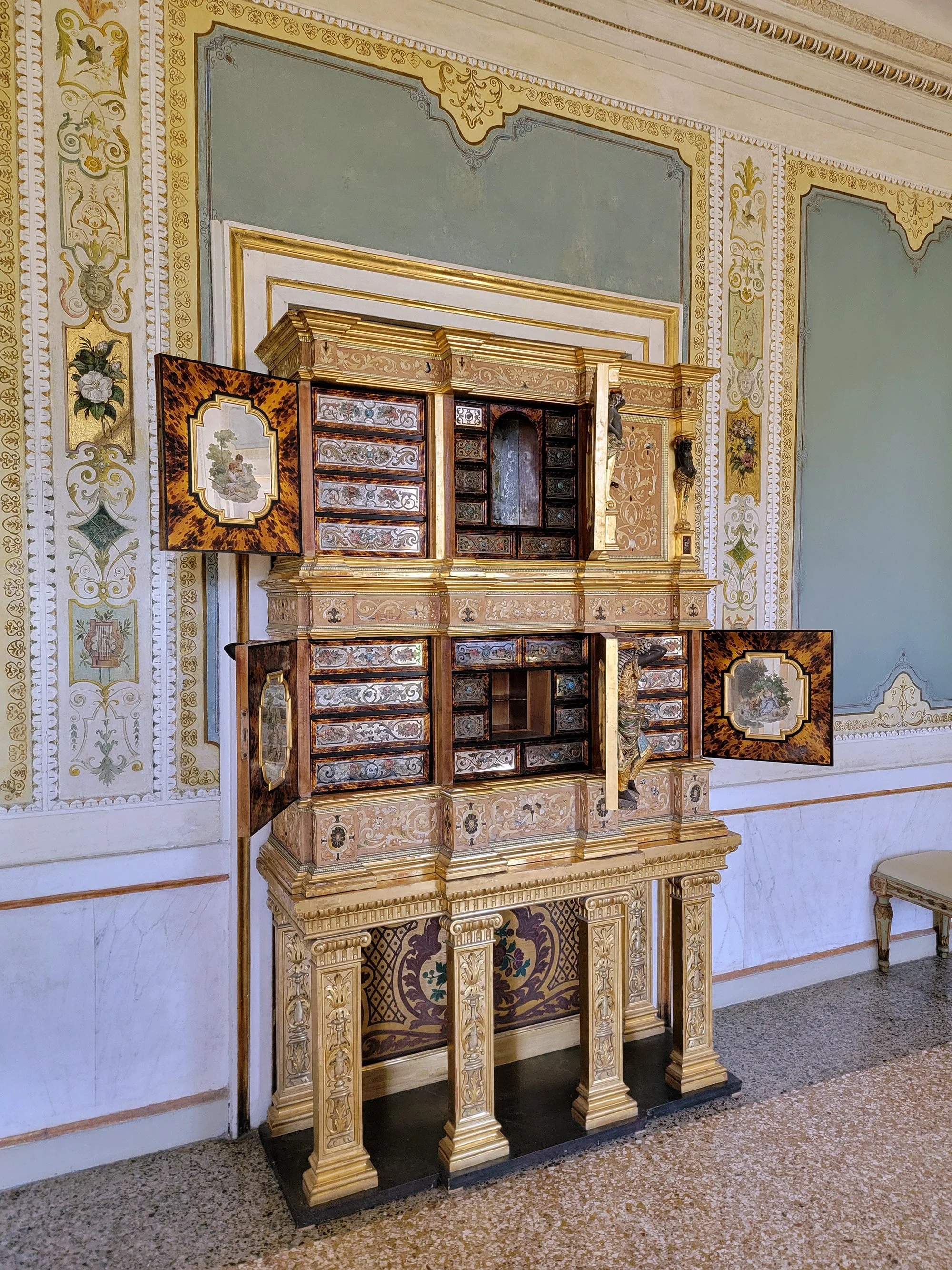 I've seen several of these ornate custom-made cabinets that have all sorts of mechanism and hidden compartments. They're awesome works of art and engineering