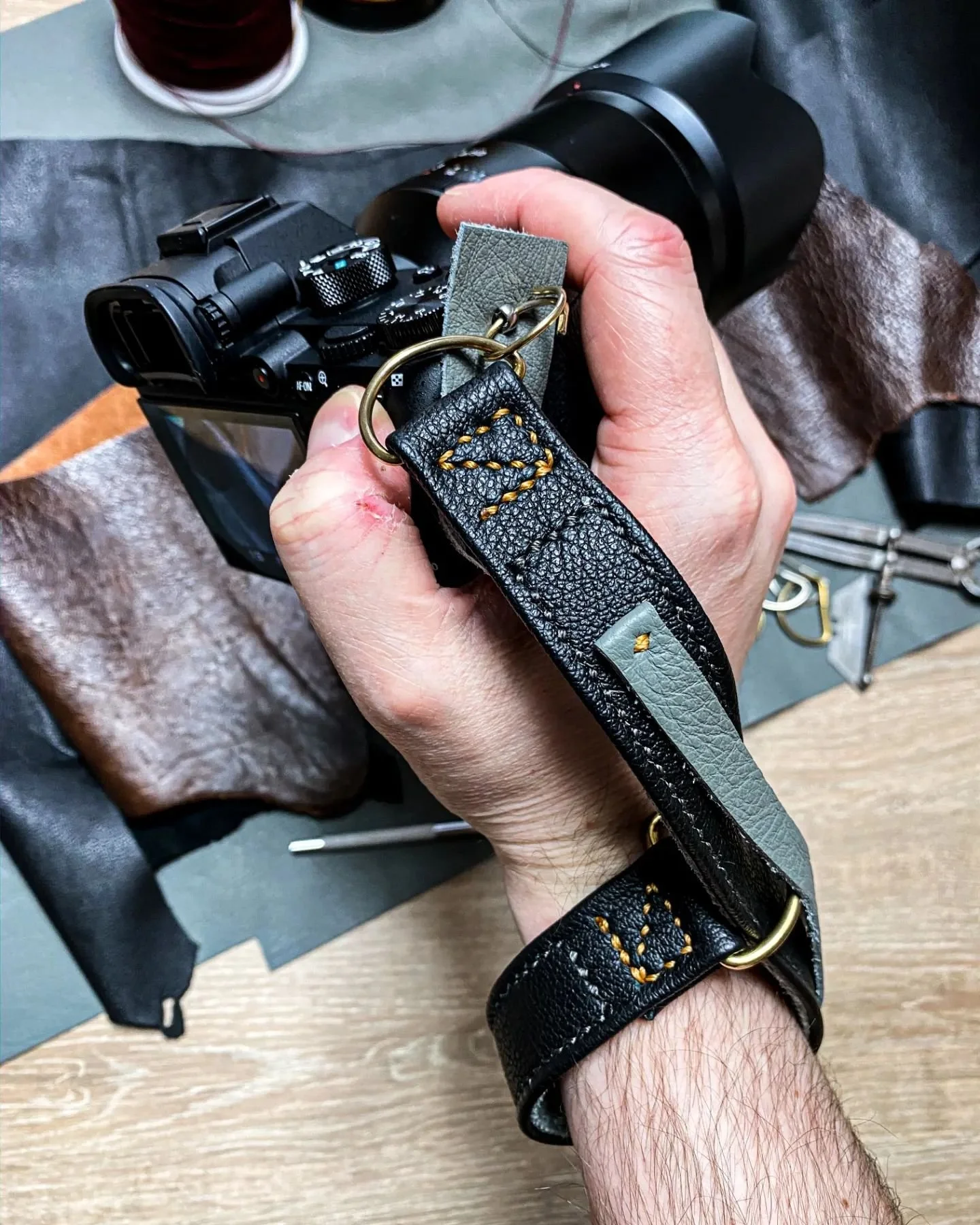 Something completely different...

While we don't currently offer camera straps as a standard product, we have made them upon request in the past, with standard 'd-ring' and Peak Design type attachment.
We are going to offer photography focused produ