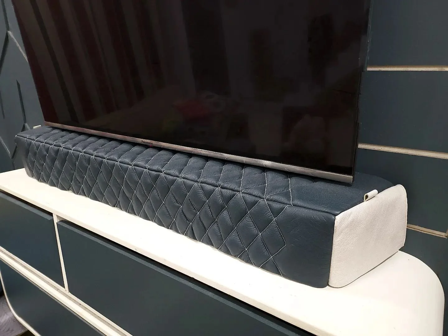 Images from a customer in Kuala Lumpur, Indonesia of a matching soundbar and sub cover (as pictured in previous series of images, below)

A dark teal and white premium leather with white stitching was requested to match the client's interior decor, t