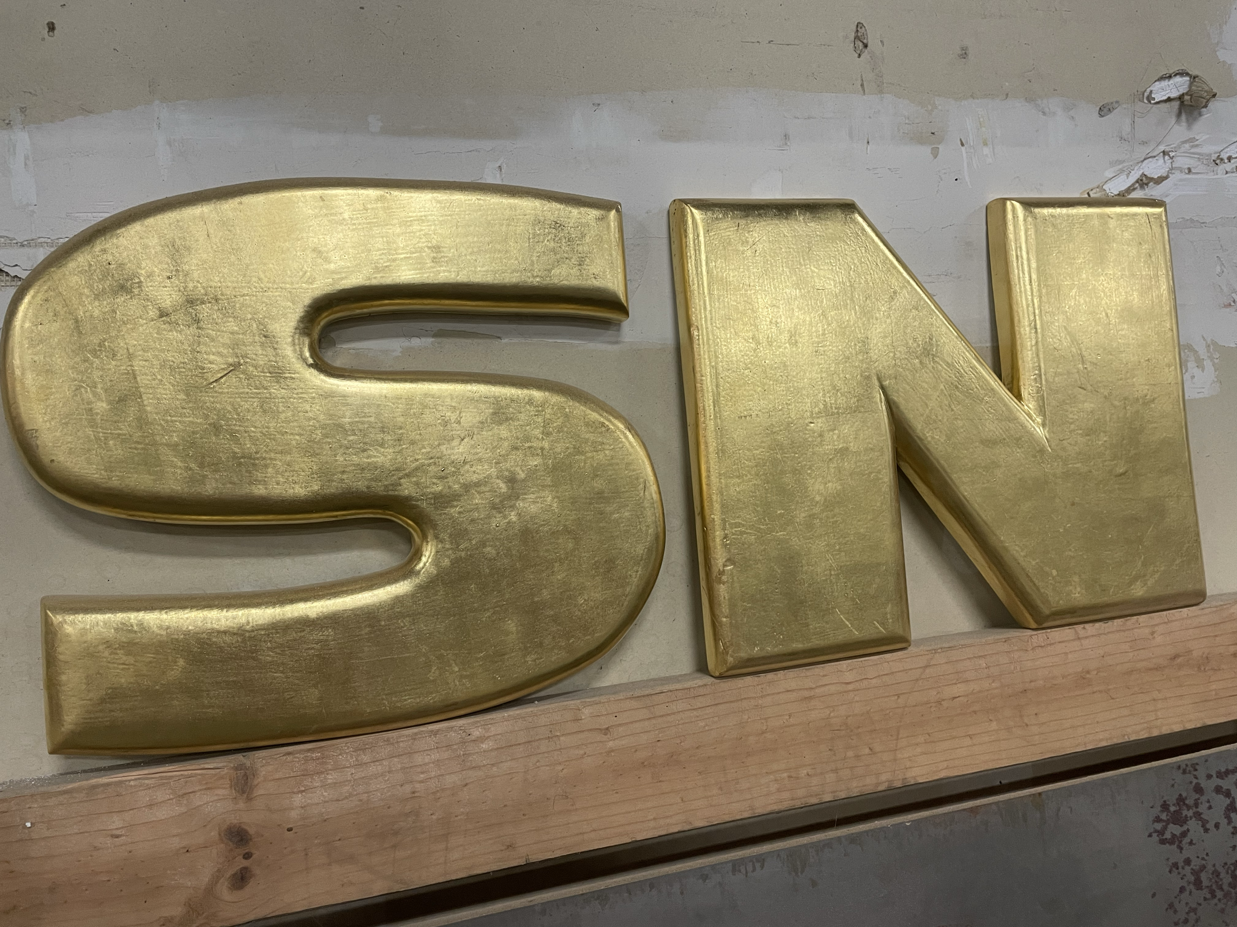 hand cut and gilded dimensional lettering