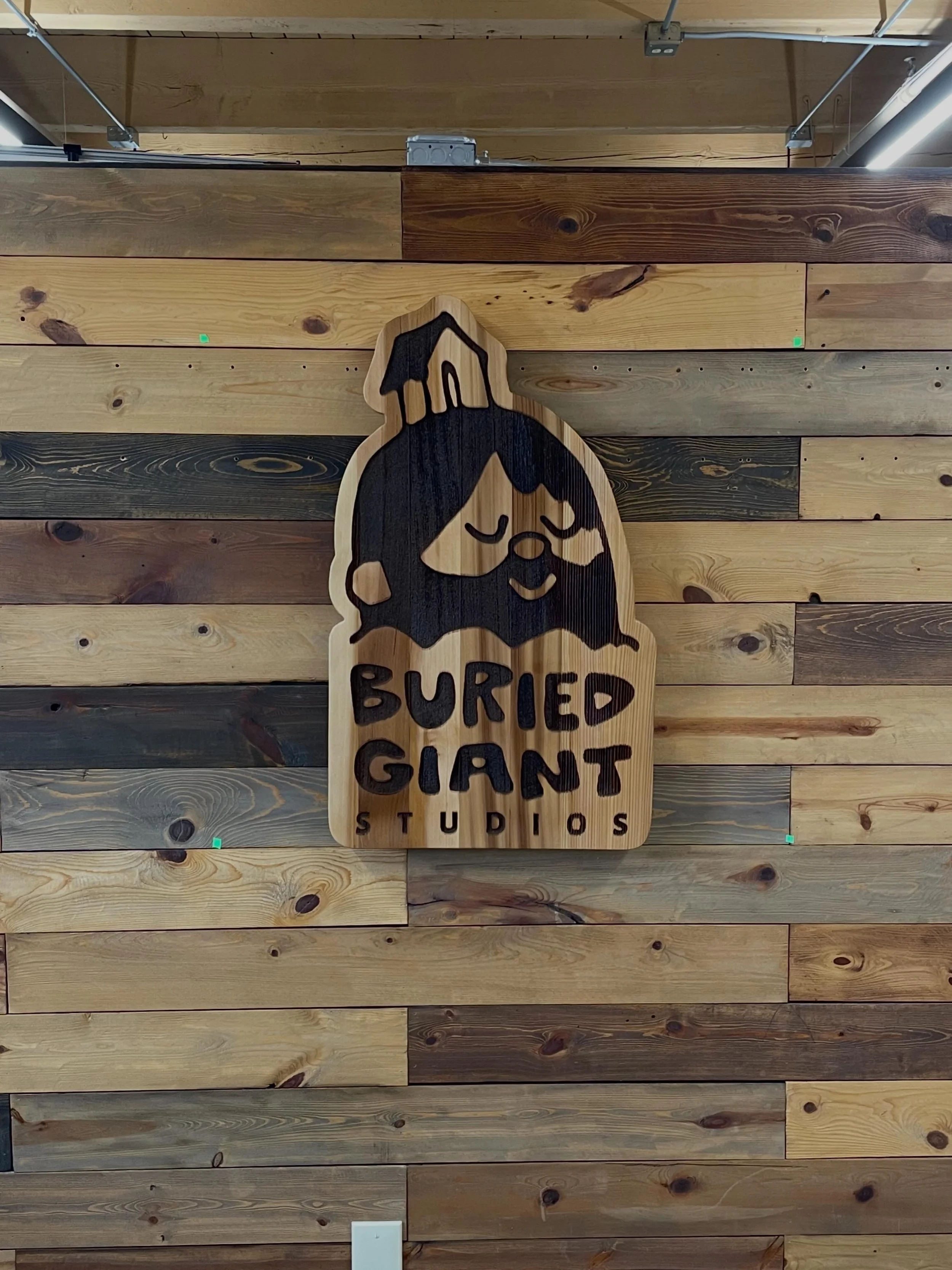 Sand blasted, stained and peg mounted entryway sign for Buried Giant Studios