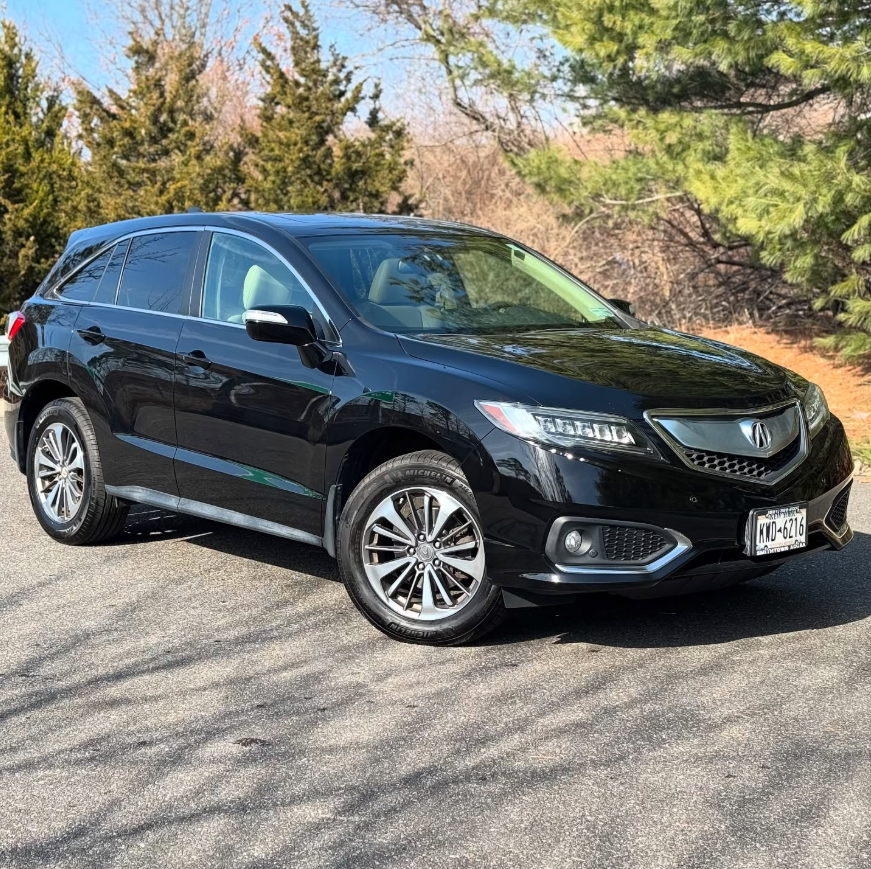 Black Acura RDX SUV with chrome accents, multi-spoke alloy wheels, and Michelin tires parked outdoors on a sunny day