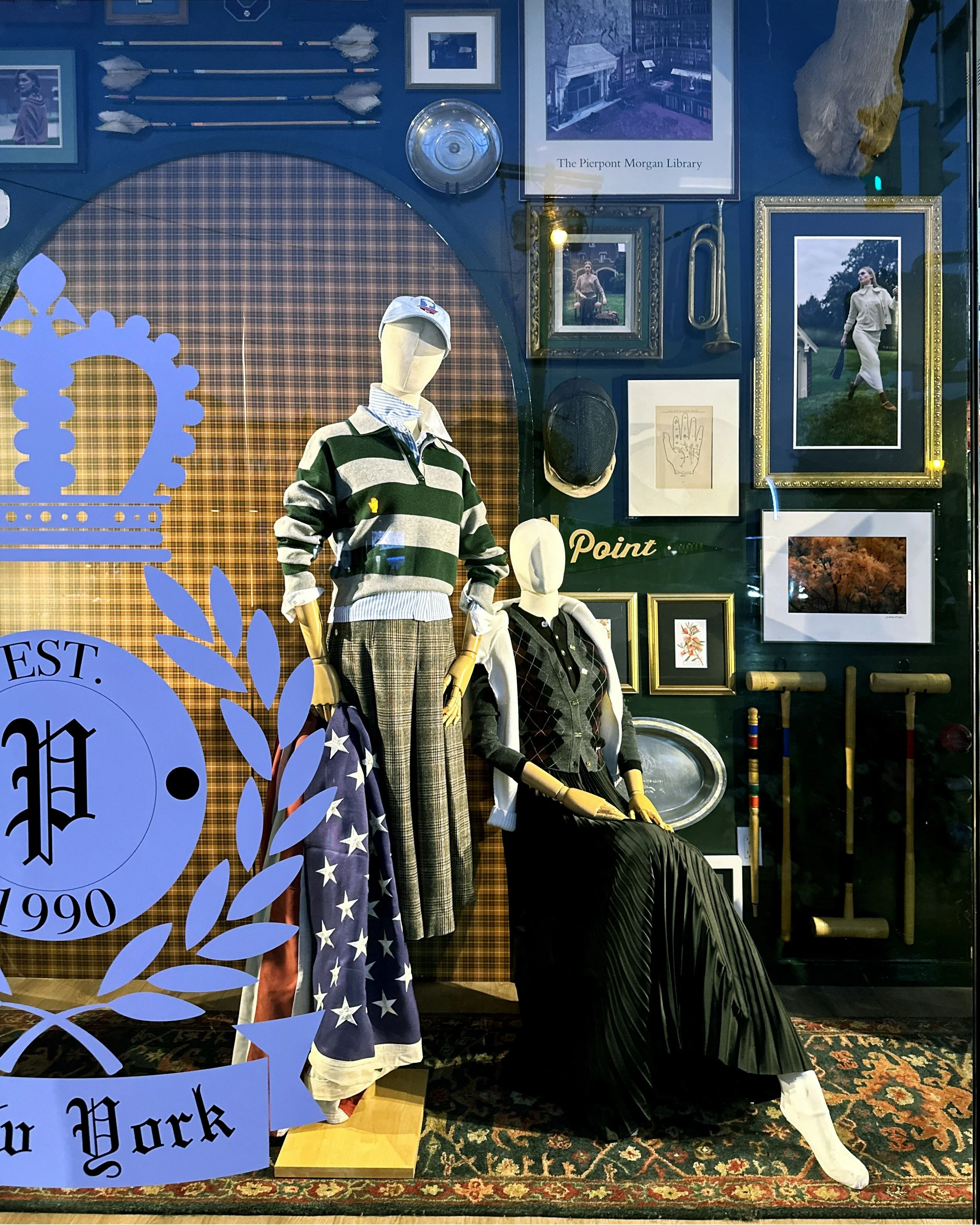 A group of preppy mannequins in a college themed window for a retail window display by Nick Sizemore