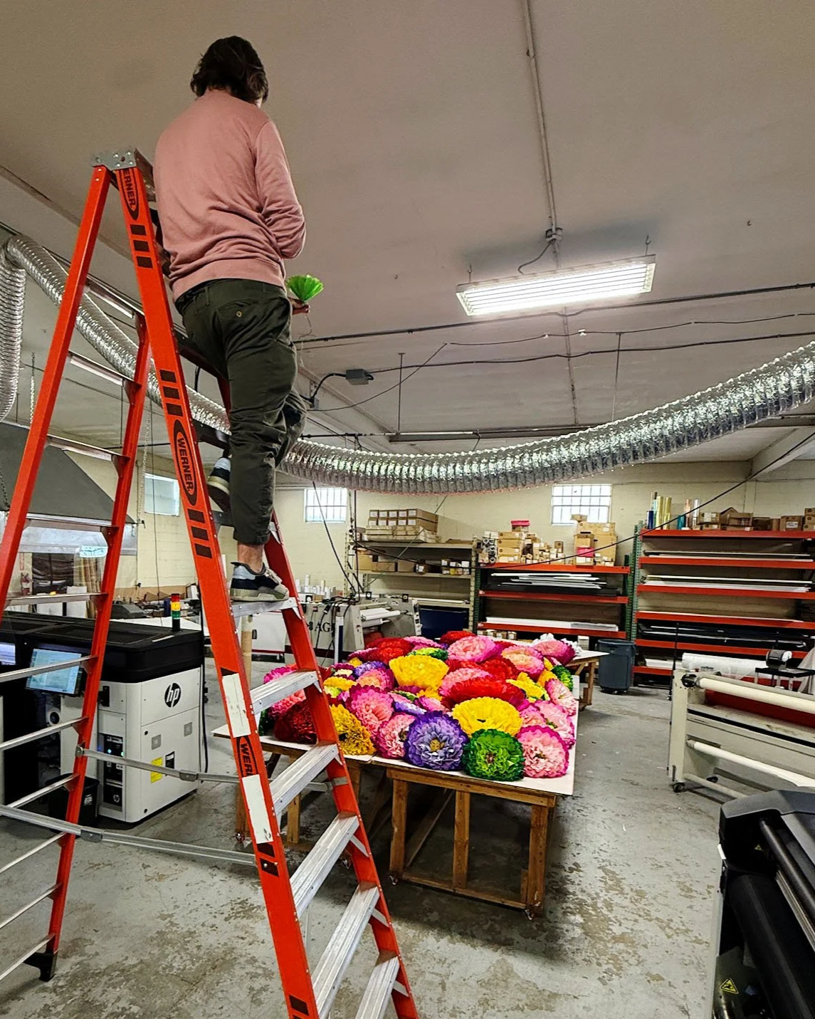 Handmaking of over 100 oversized crepe flowers