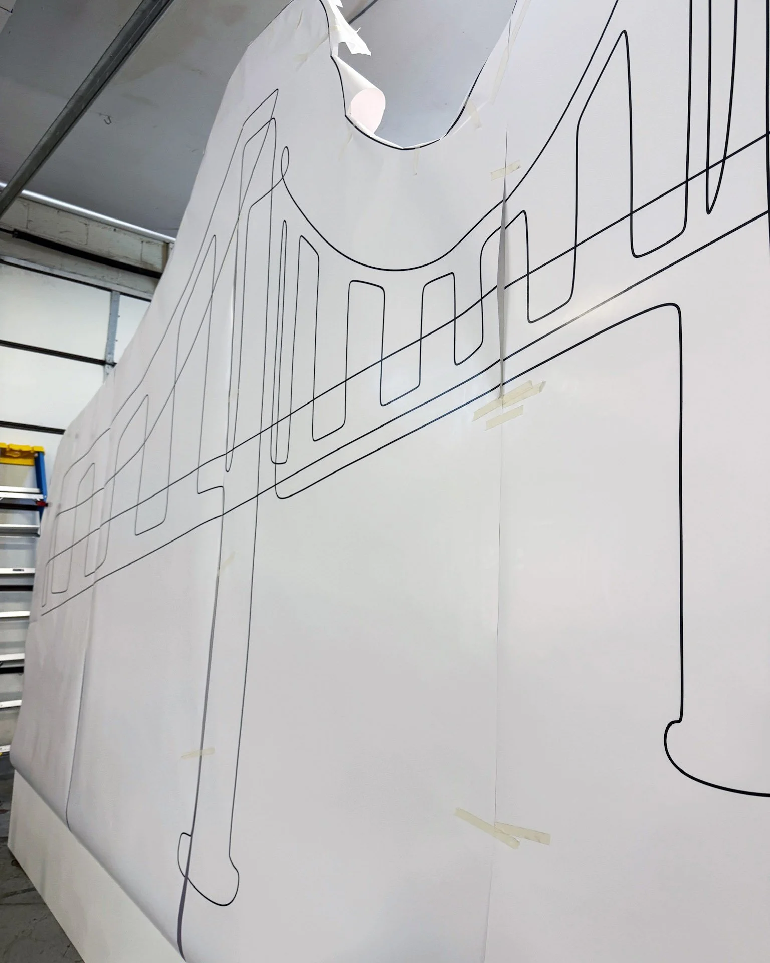 The line art taped into place for a guide. 