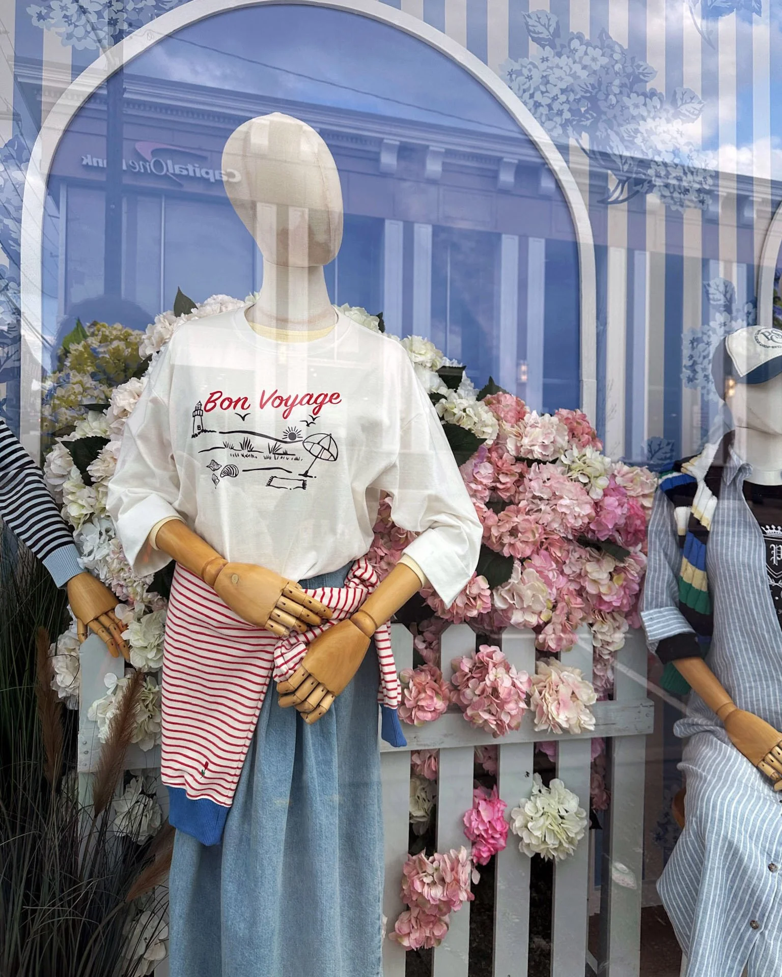 READY TO WEAR WINDOW DESIGN WITH CUSTOM WALL PAPER AND CUSTOM hydrangea HEDGES AND BUSH