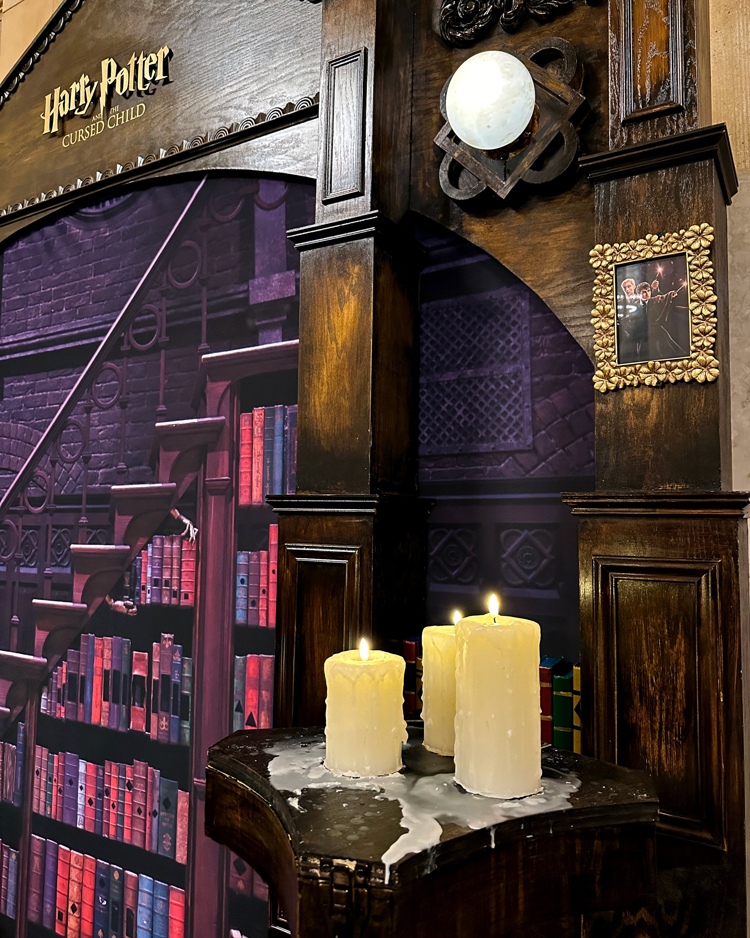 Close up of the "Harry Potter and The Cursed Child" photo booth in Grand Central displaying the hand made wood structure and props.